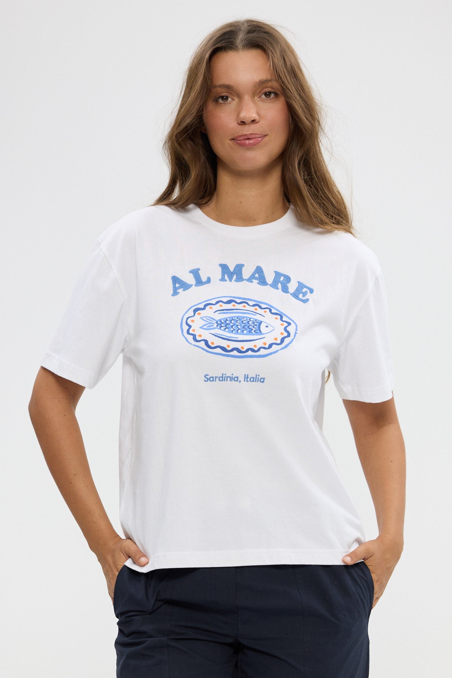 Woman wearing a white t-shirt with 'Al Mare' branding on a plain background
