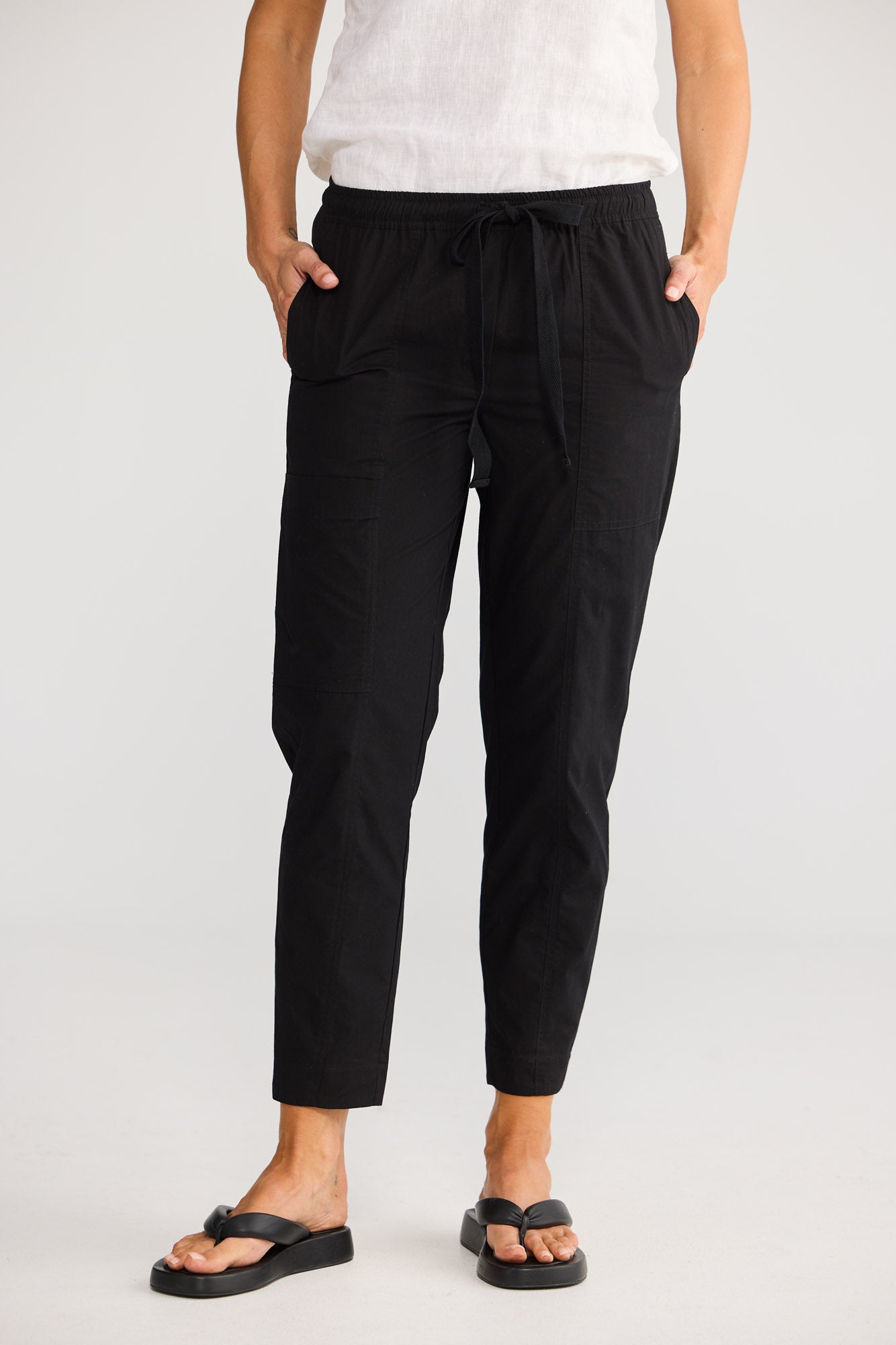 Reva Cargo Pant in Black with front and back design seams with split at back hem.