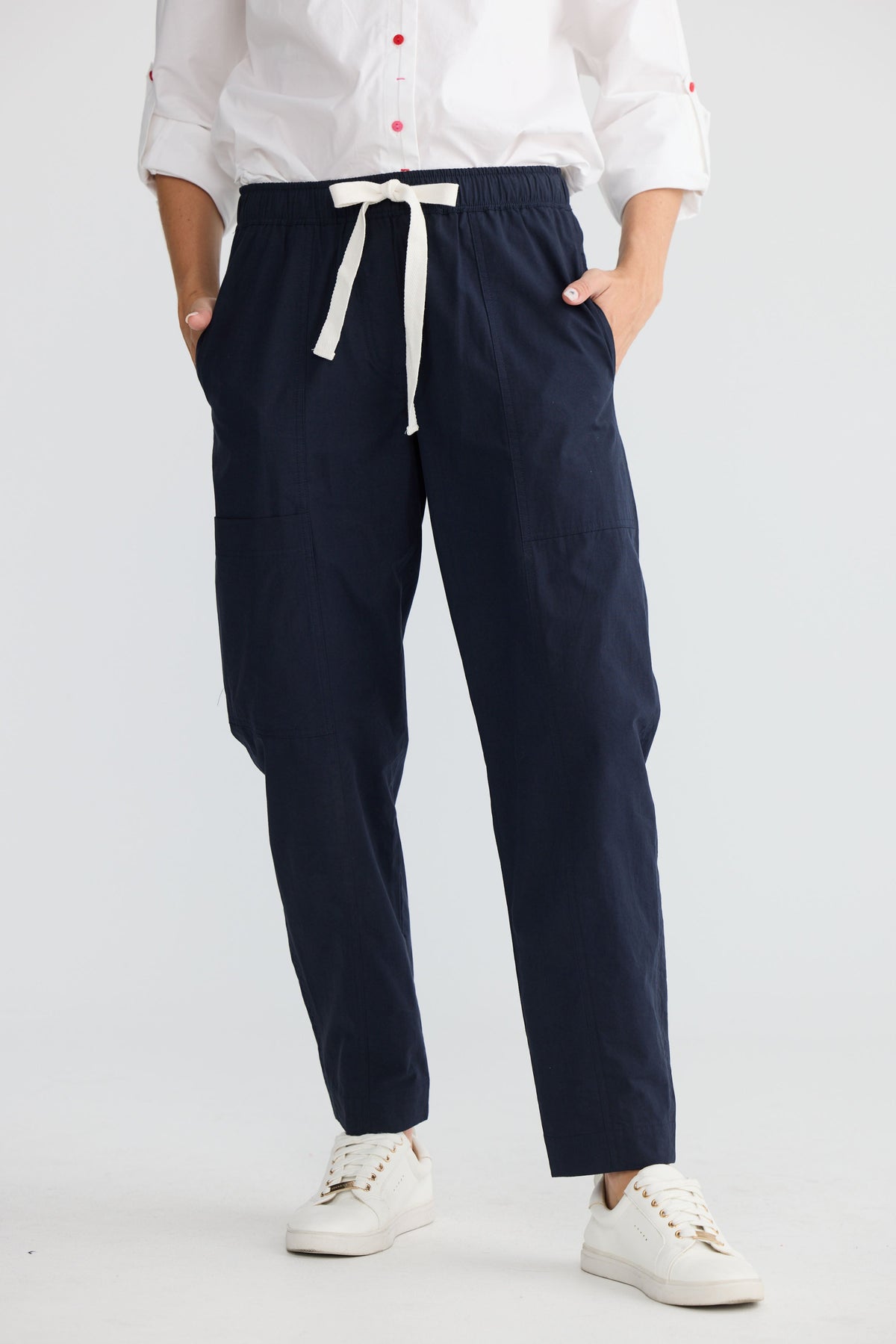 Model wearing Reva Cargo Pant in navy, front view. Tie waistband, cargo-style pockets.