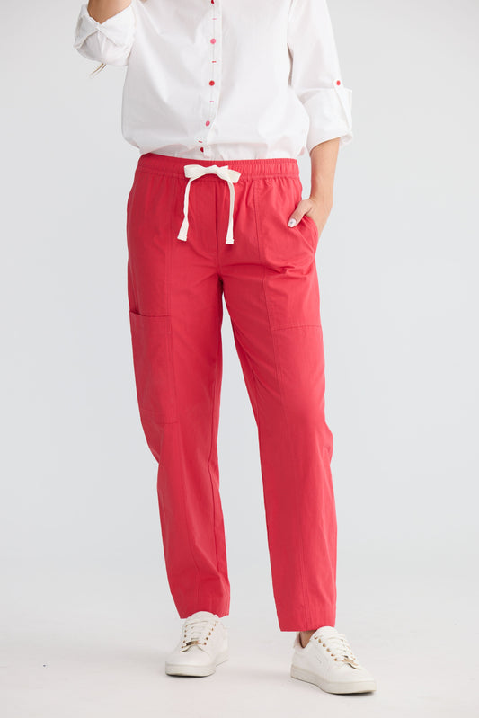 Model wearing Reva Cargo Pant Red with drawstring waist and cargo pockets, front view on white background