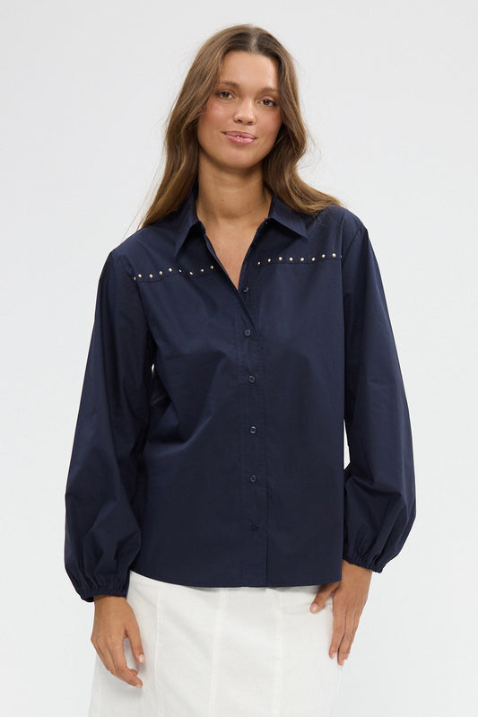 Woman wearing a navy blouse on a white background