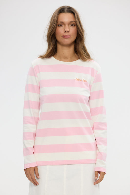 Woman wearing a pink and white striped sweater on a white background