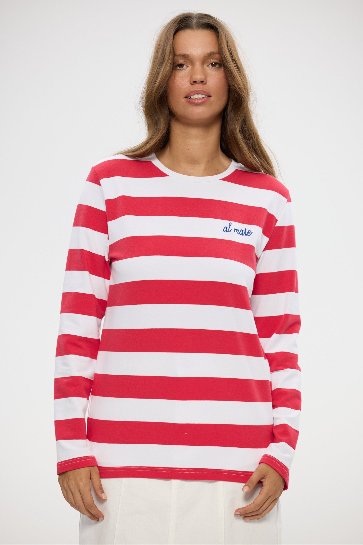 Woman wearing a red and white striped long-sleeve shirt with 'al mare' branding on a white background