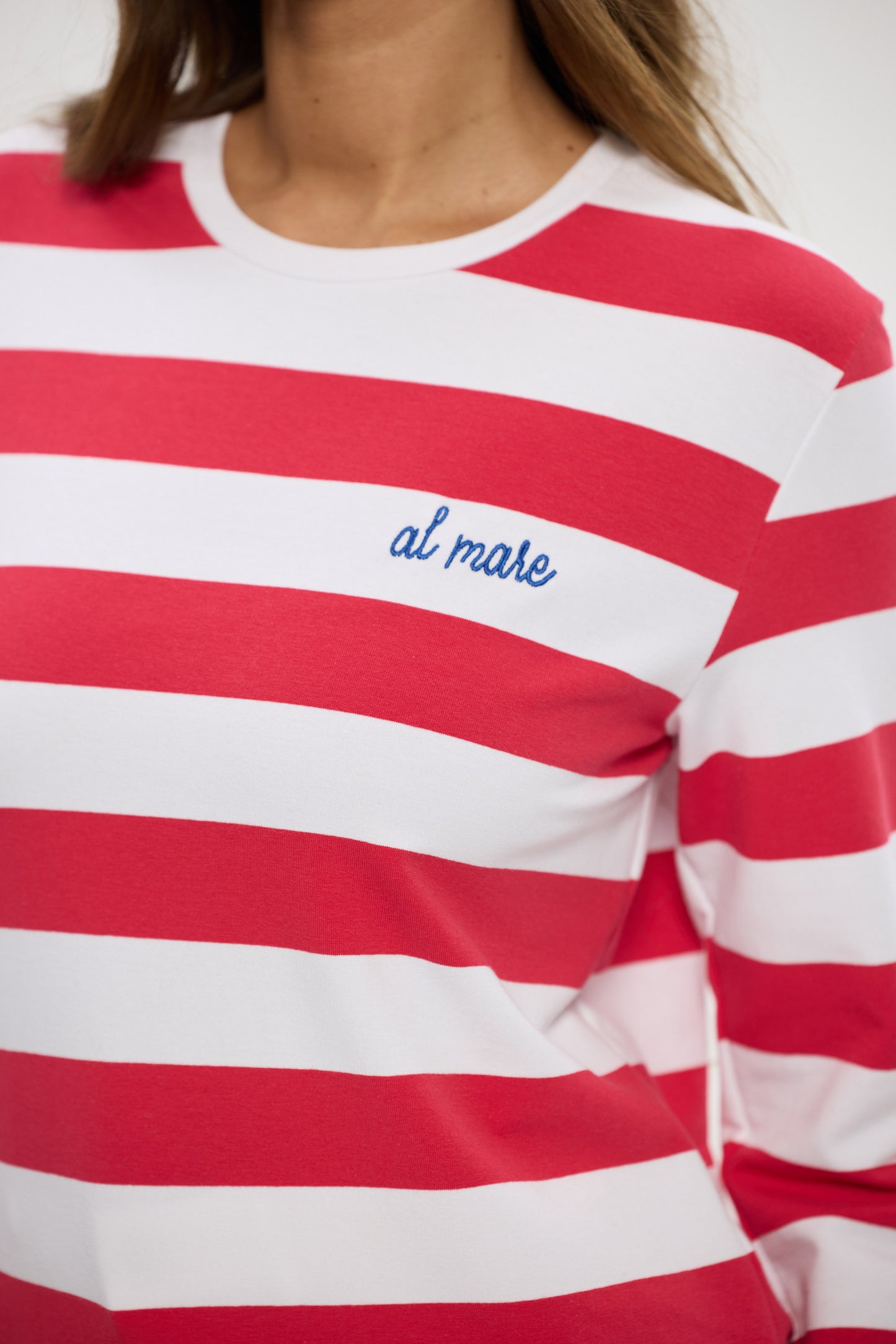 Red and white striped shirt with 'al mare' text on a plain background
