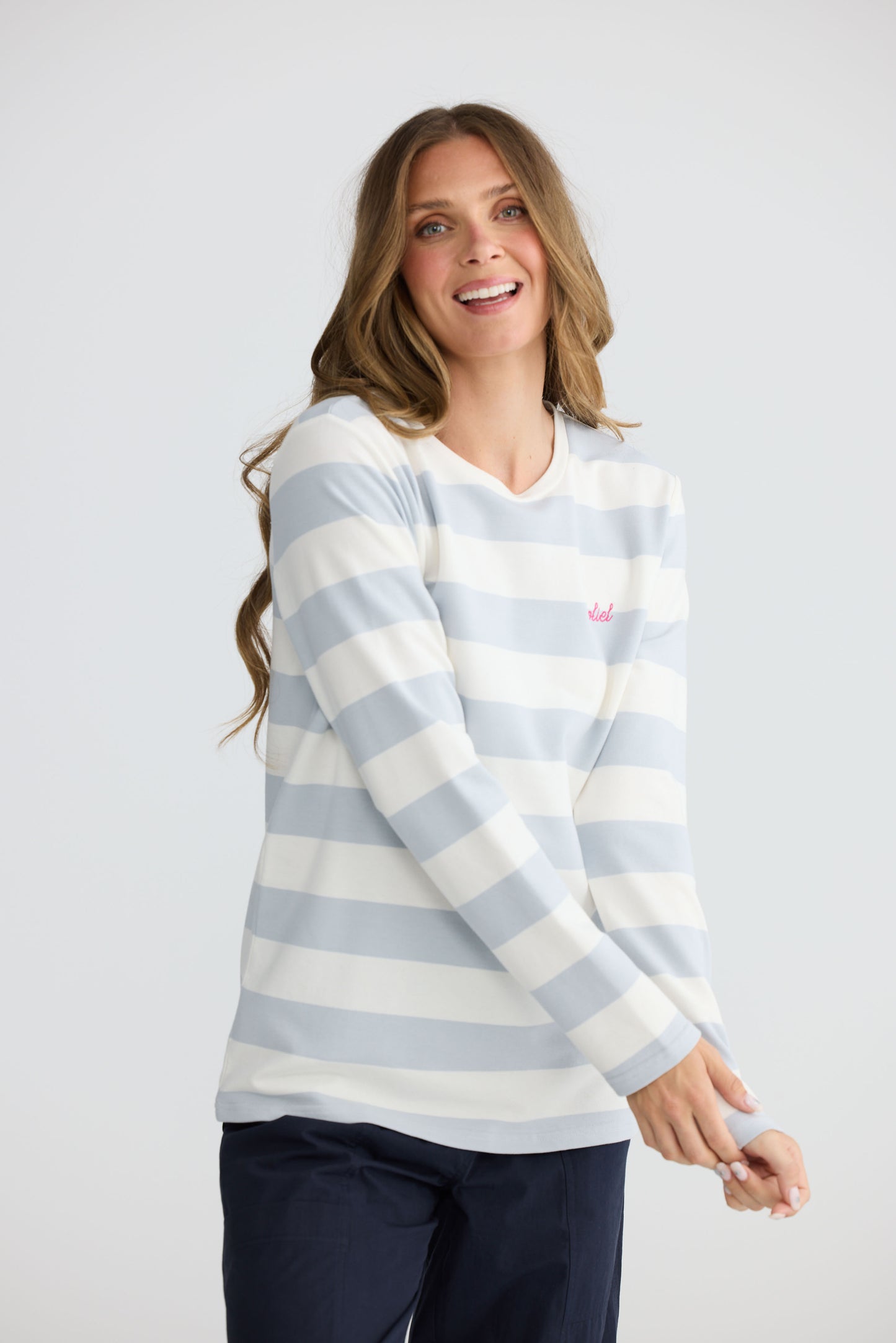 Model wearing Roam Tee Light Blue Stripe with long sleeves and striped finish, full-length view on white background