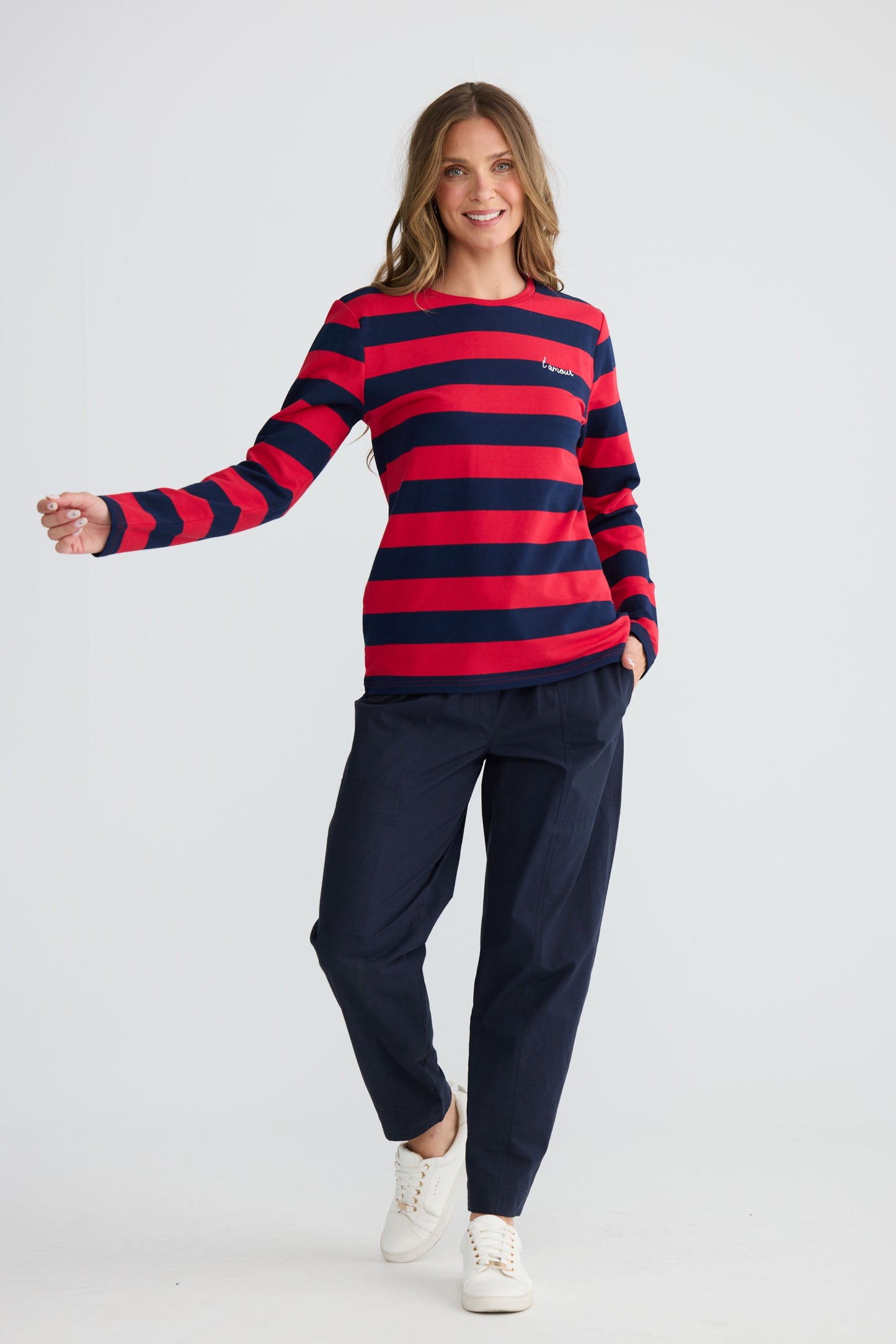 Model wearing Roam Tee Red and Navy Stripe with long sleeves and striped finish, front view on white background