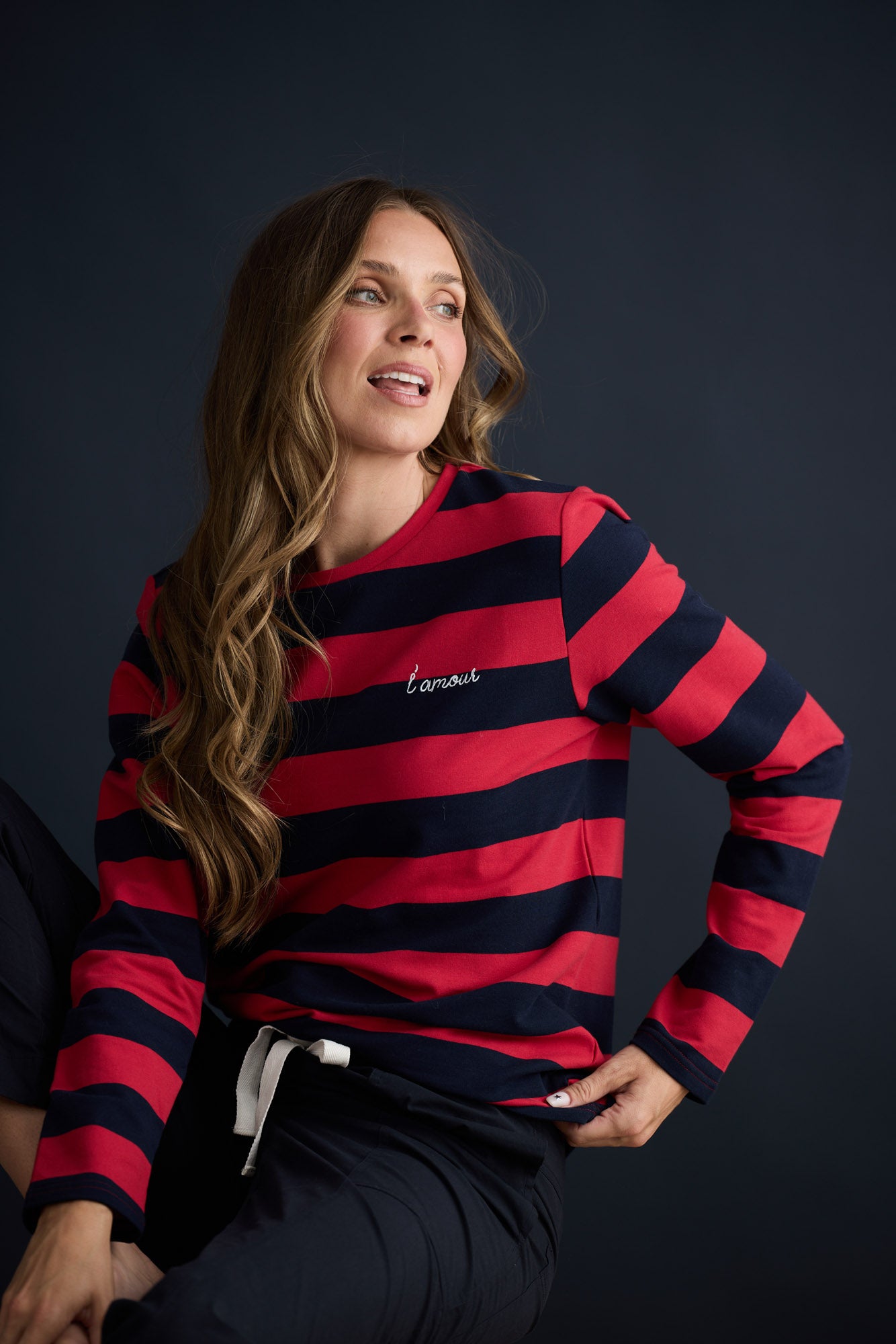 Model wearing Roam Tee Red and Navy Stripe with long sleeves and striped finish, campaign lifestyle view