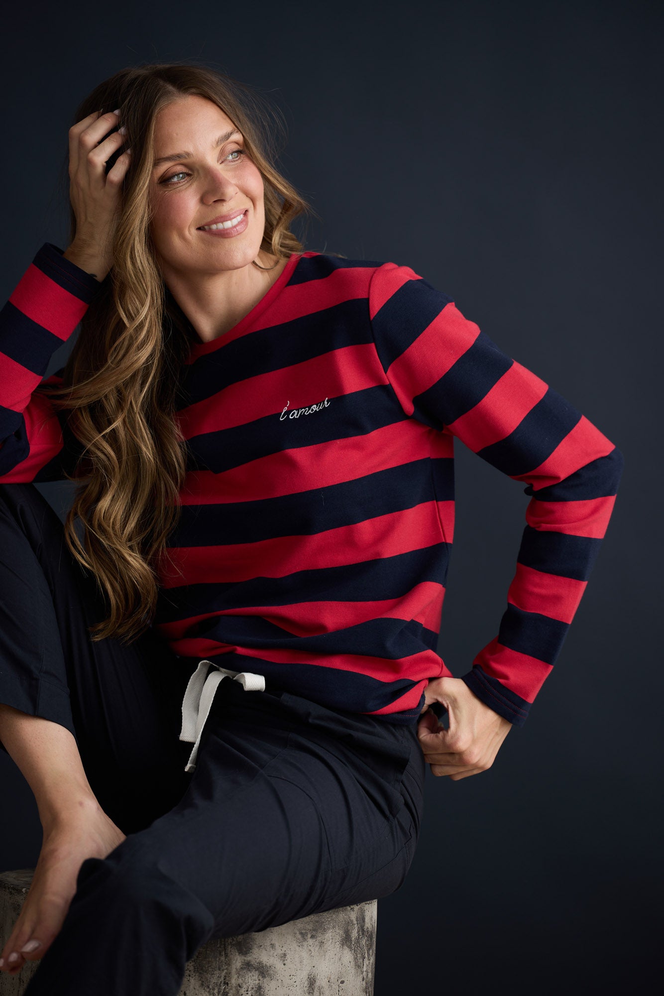 Model wearing Roam Tee Red and Navy Stripe with long sleeves and striped finish, campaign lifestyle view