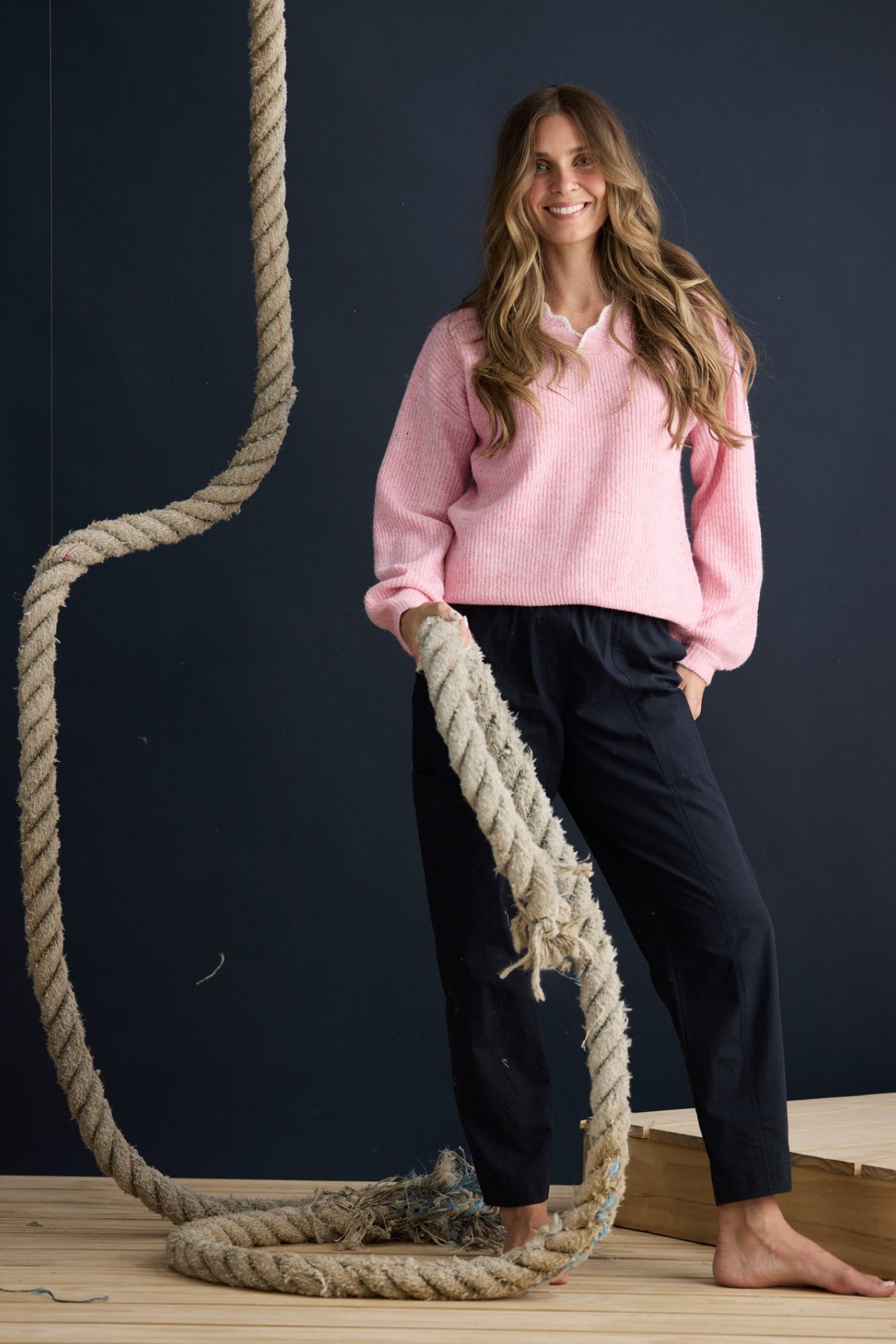 Model wearing Ocean Knit Pink with scalloped V-neckline, campaign lifestyle view