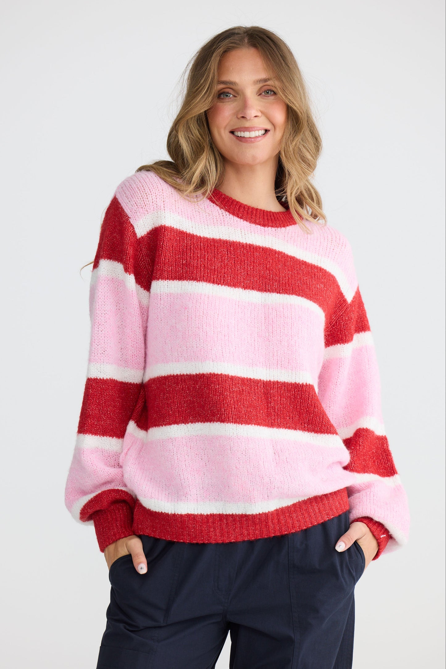Model wearing Cove Knit Pink Multi Stripe with multi stripe knit finish, alternate view on white background