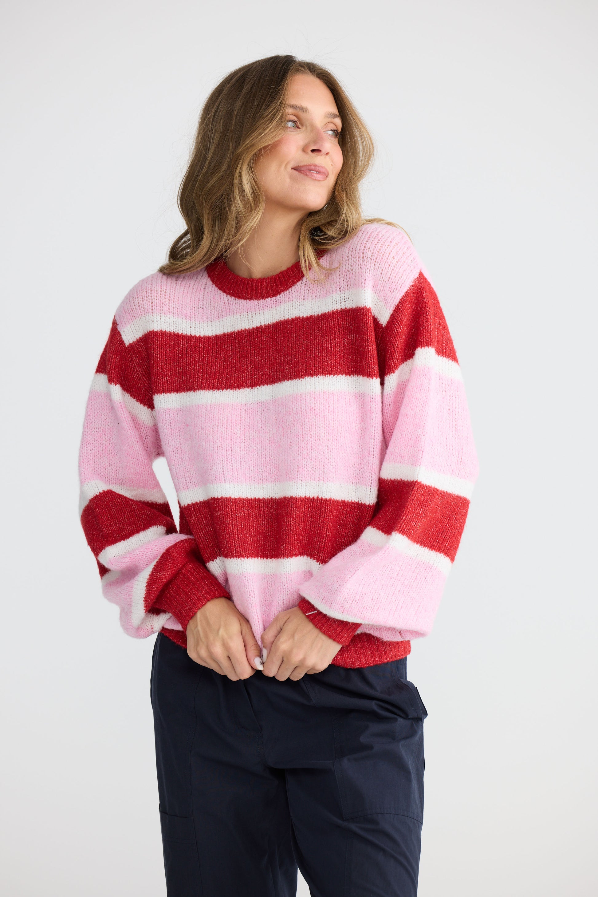 Model wearing Cove Knit Pink Multi Stripe with multi stripe knit finish, back view on white background