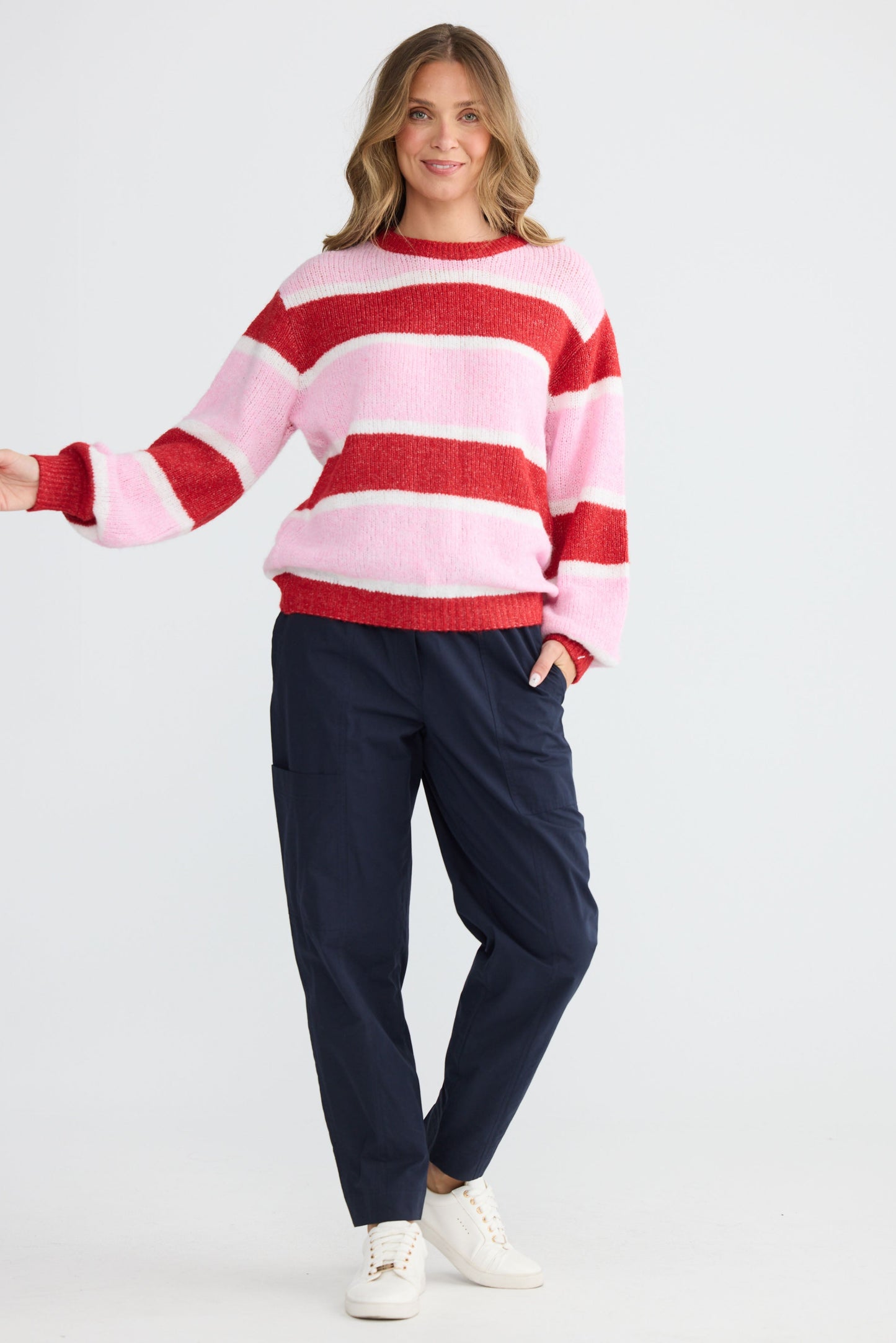 Model wearing Cove Knit Pink Multi Stripe with multi stripe knit finish, detail view on white background