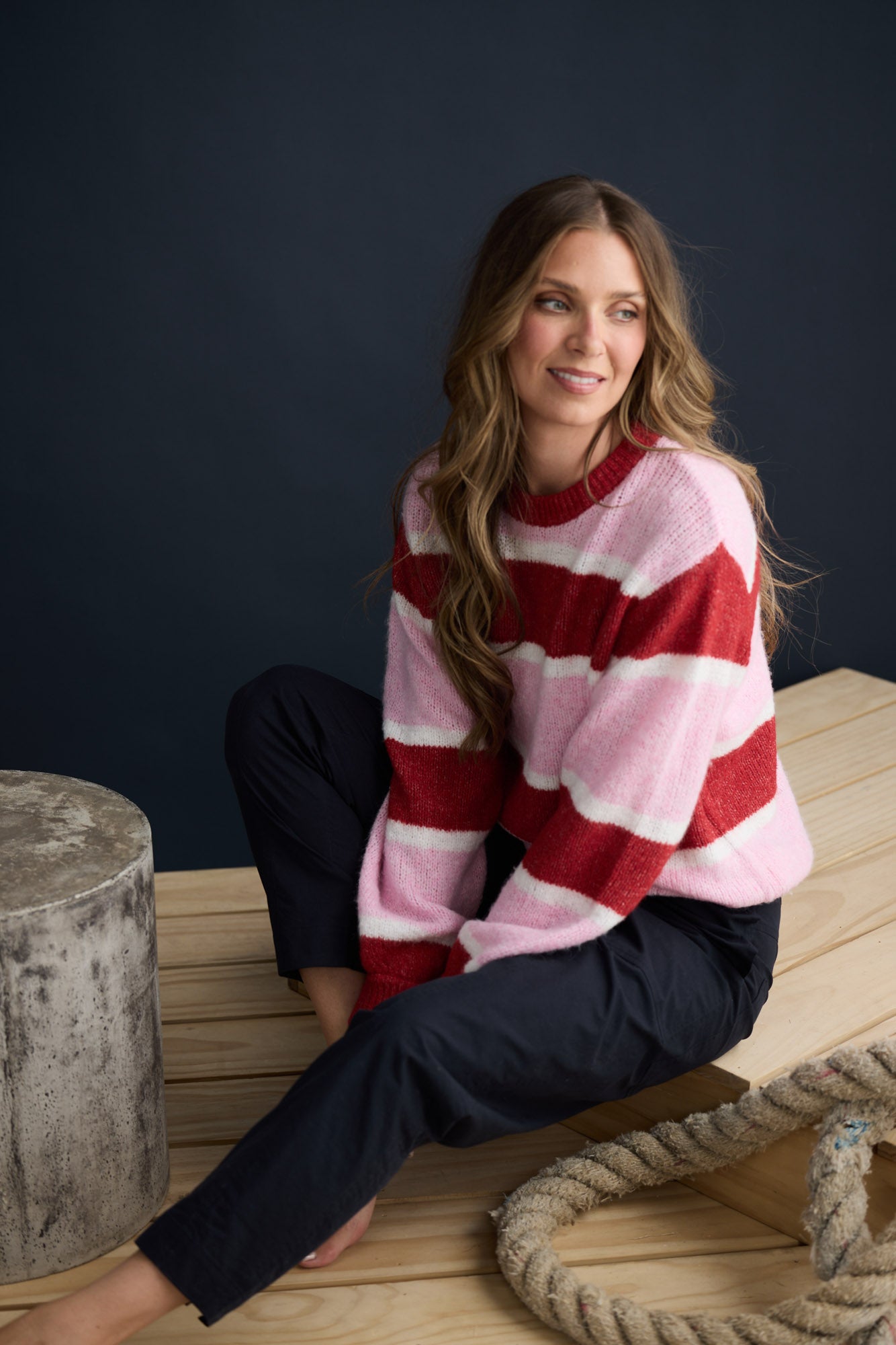 Model wearing Cove Knit Pink Multi Stripe with multi stripe knit finish, campaign lifestyle view