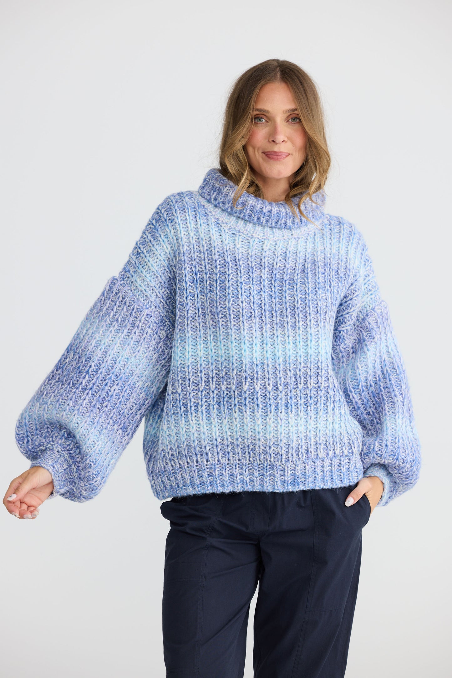 Model wearing Olas Knit Blue Ombre with chunky high neckline, alternate view on white background