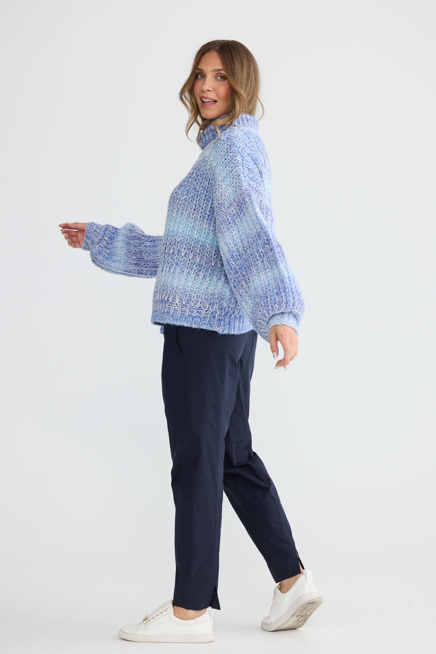 Model wearing Olas Knit Blue Ombre with chunky high neckline, detail view on white background