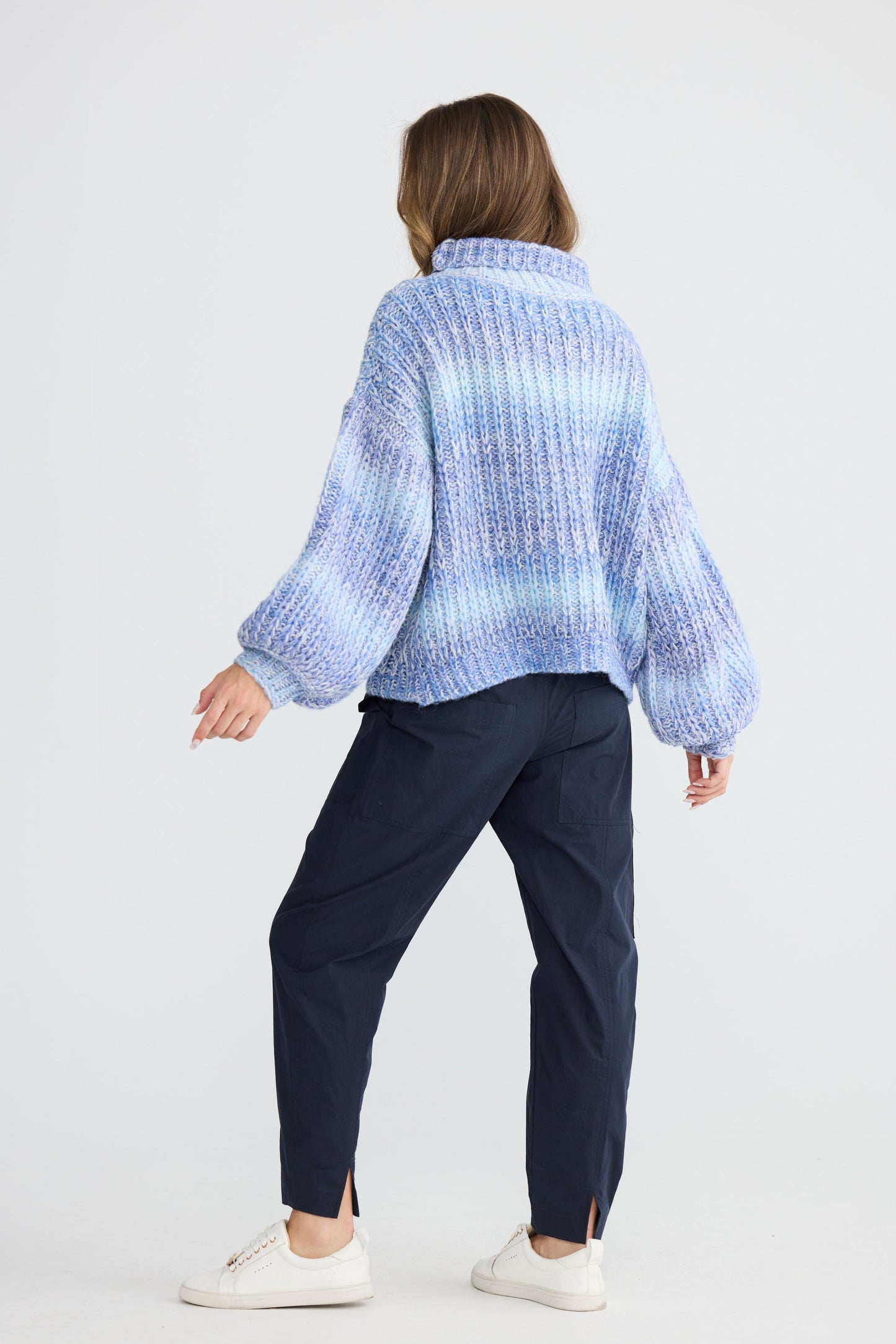 Model wearing Olas Knit Blue Ombre with chunky high neckline, full-length view on white background