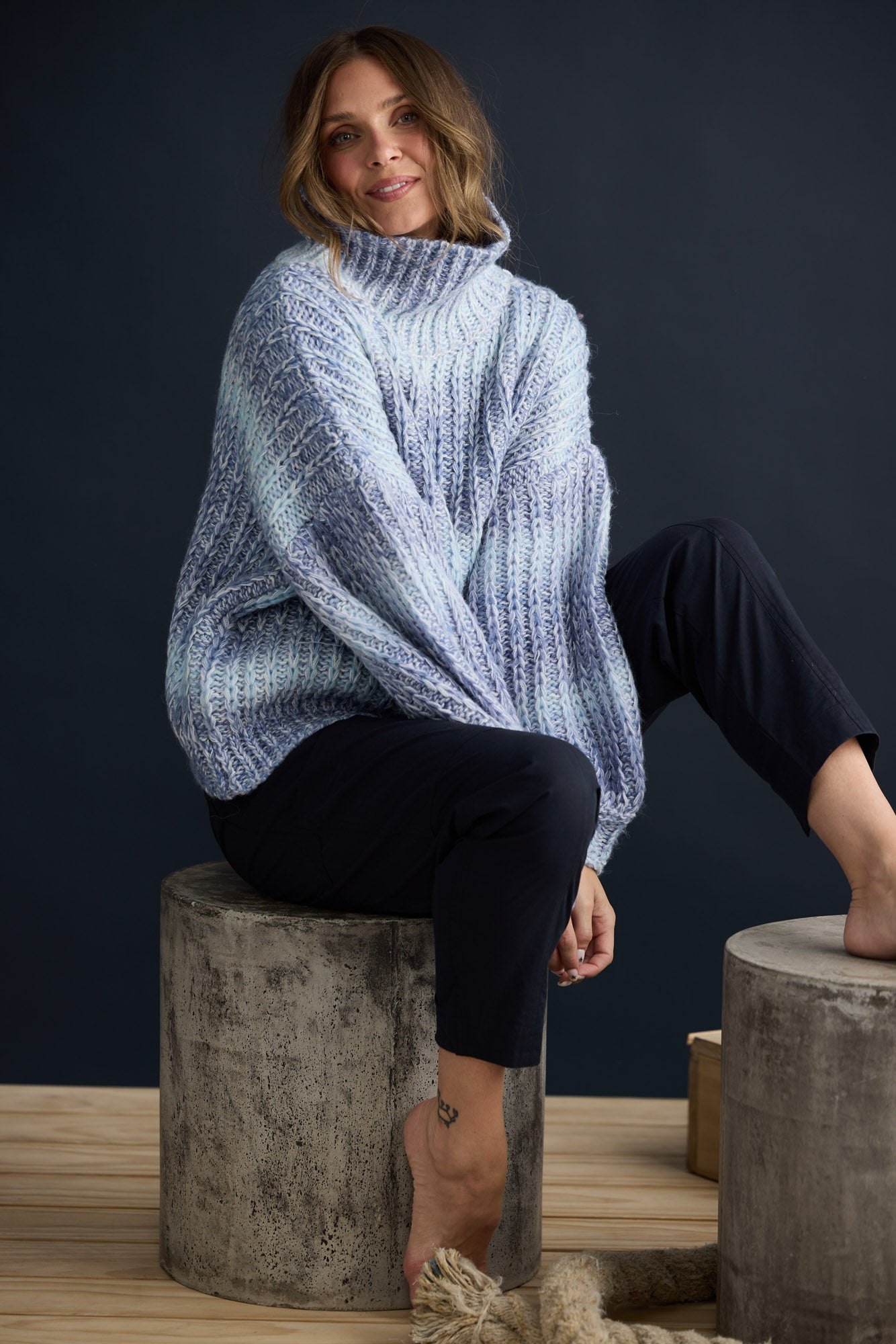 Model wearing Olas Knit Blue Ombre with chunky high neckline, campaign lifestyle view
