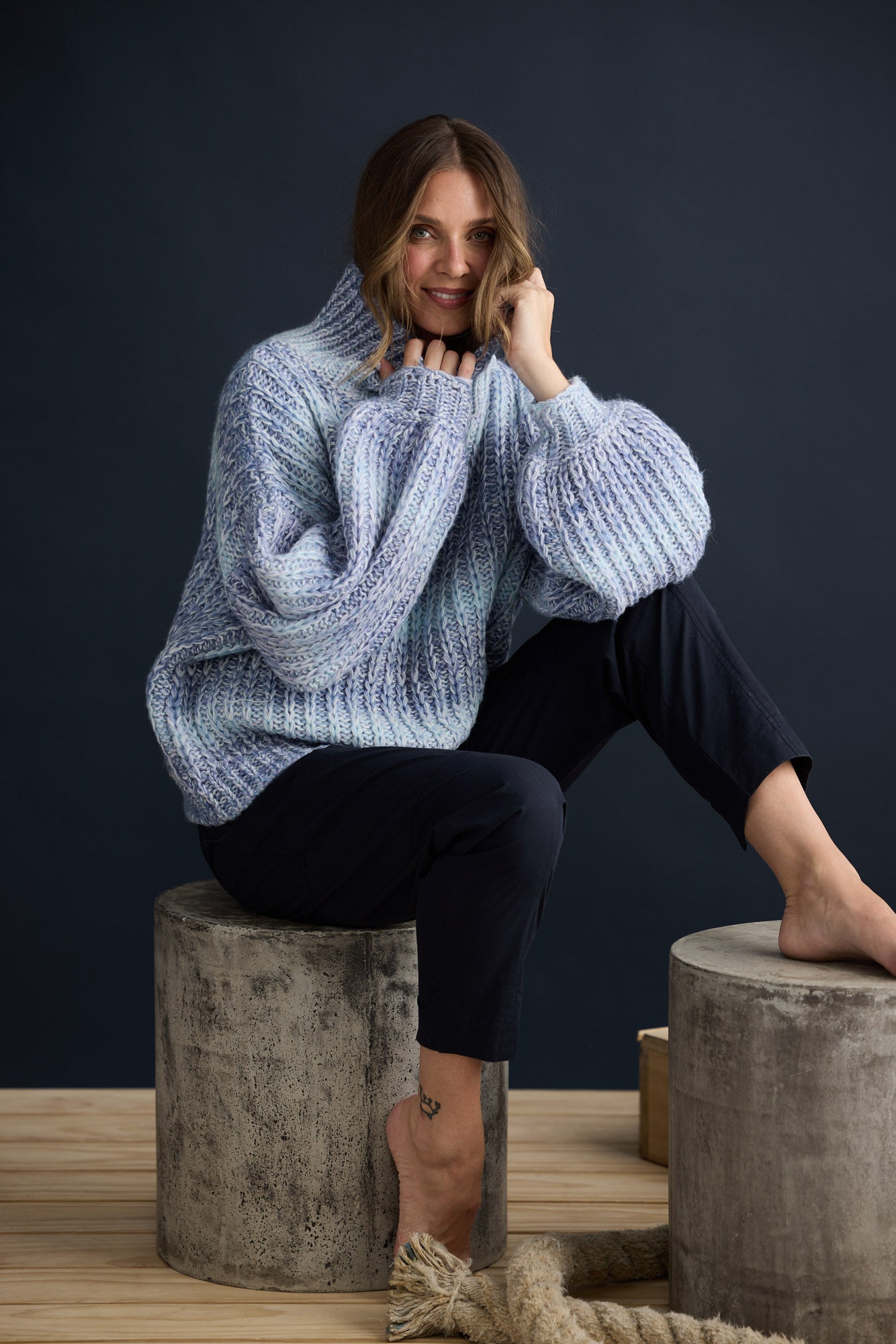 Model wearing Olas Knit Blue Ombre with chunky high neckline, campaign lifestyle view