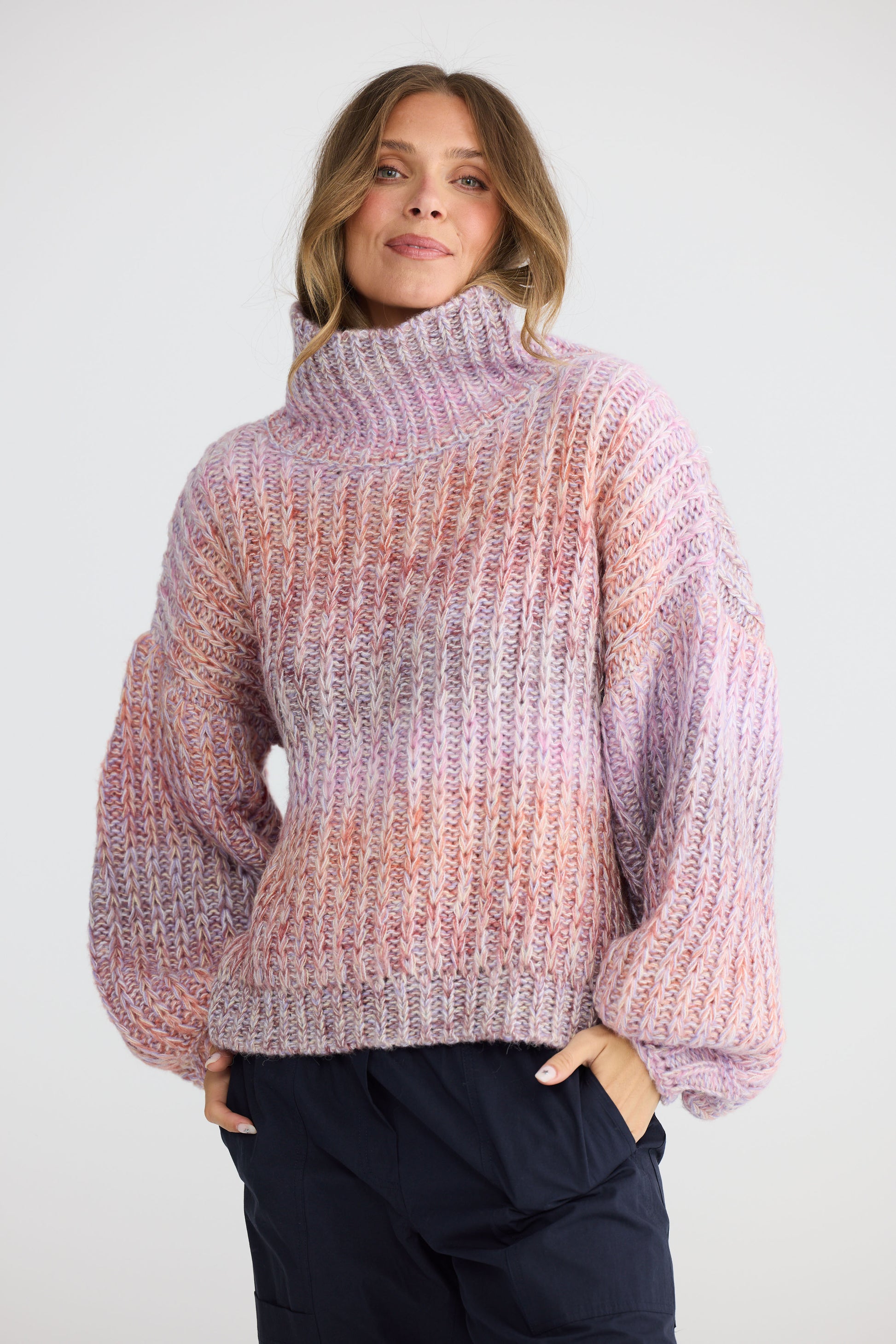 Model wearing Olas Knit Pink Ombre with chunky high neckline, detail view on white background