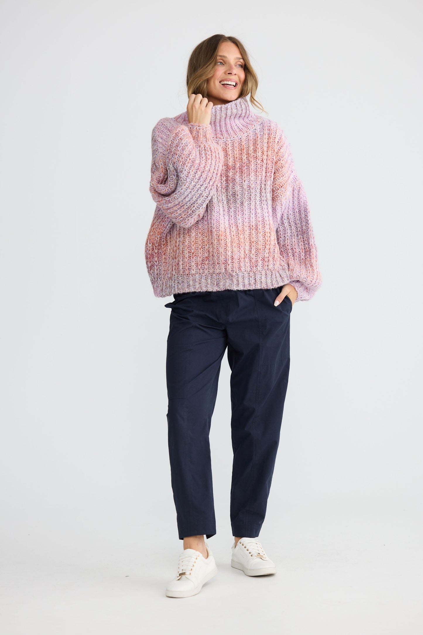 Model wearing Olas Knit Pink Ombre with chunky high neckline, front view on white background