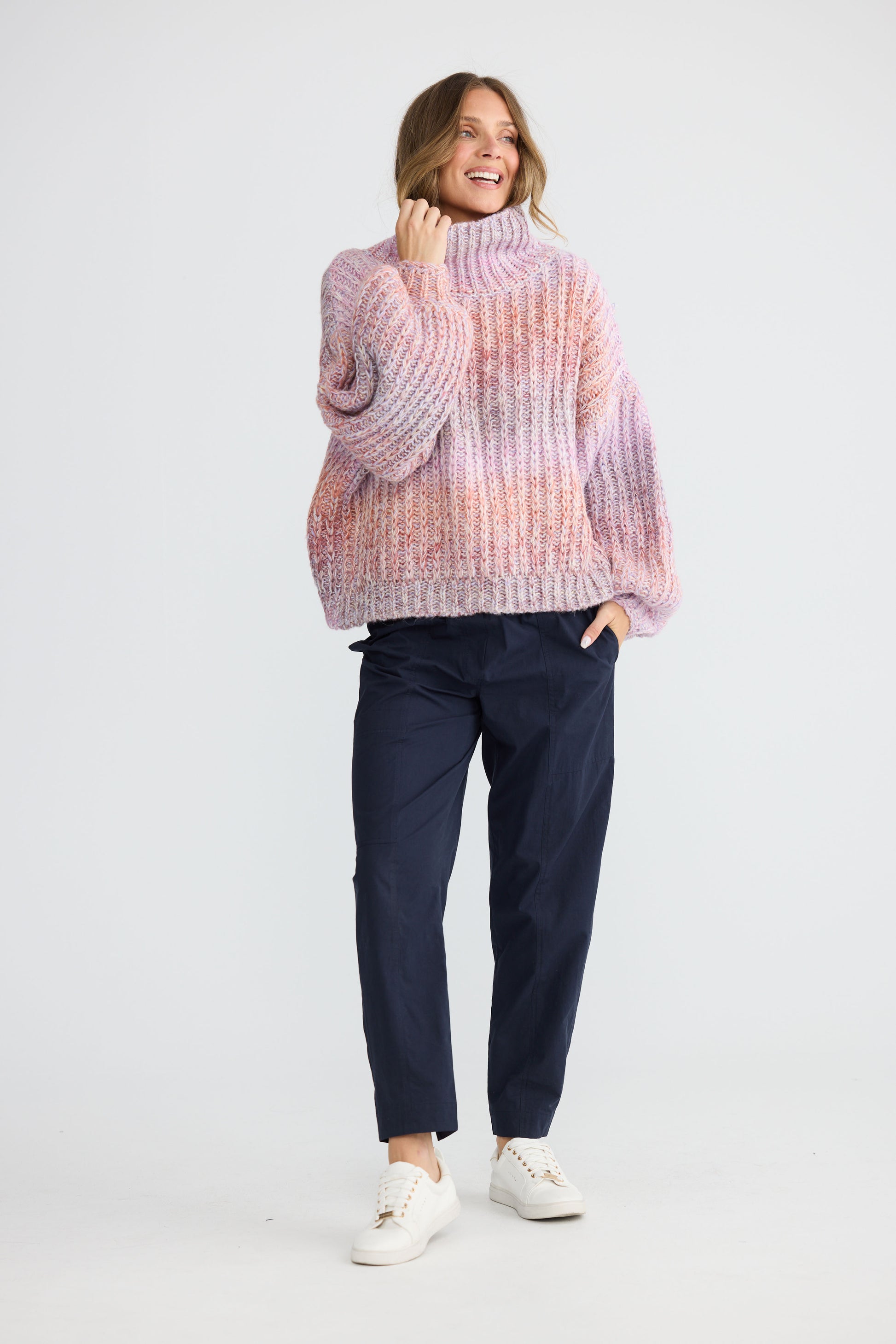 Model wearing Olas Knit Pink Ombre with chunky high neckline, front view on white background