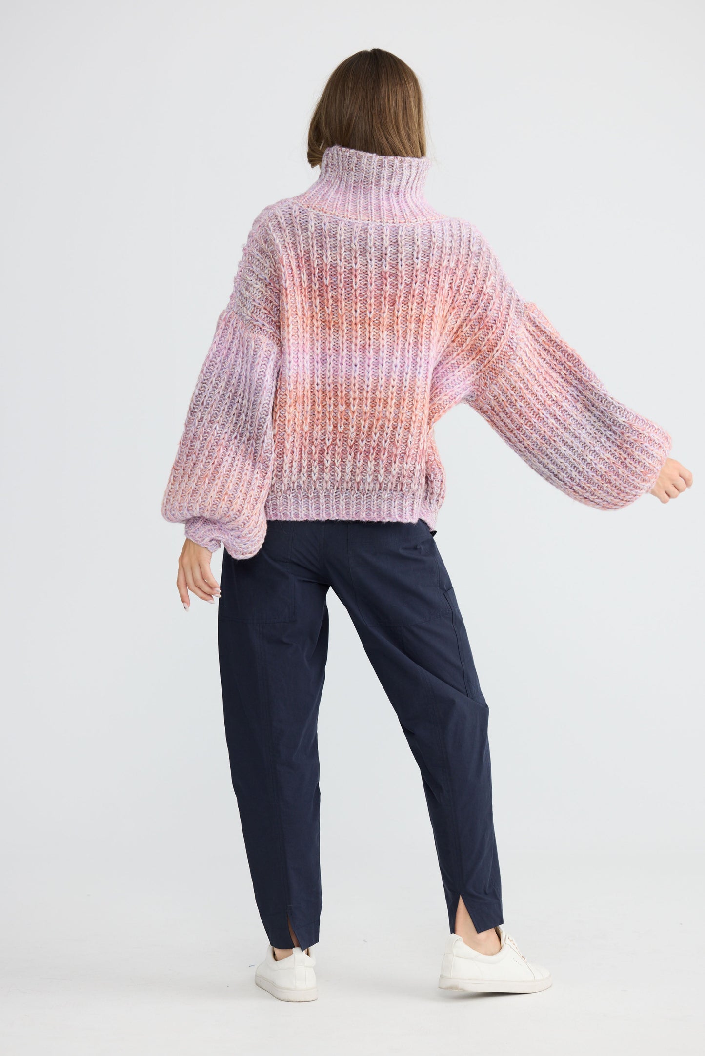 Model wearing Olas Knit Pink Ombre with chunky high neckline, alternate view on white background