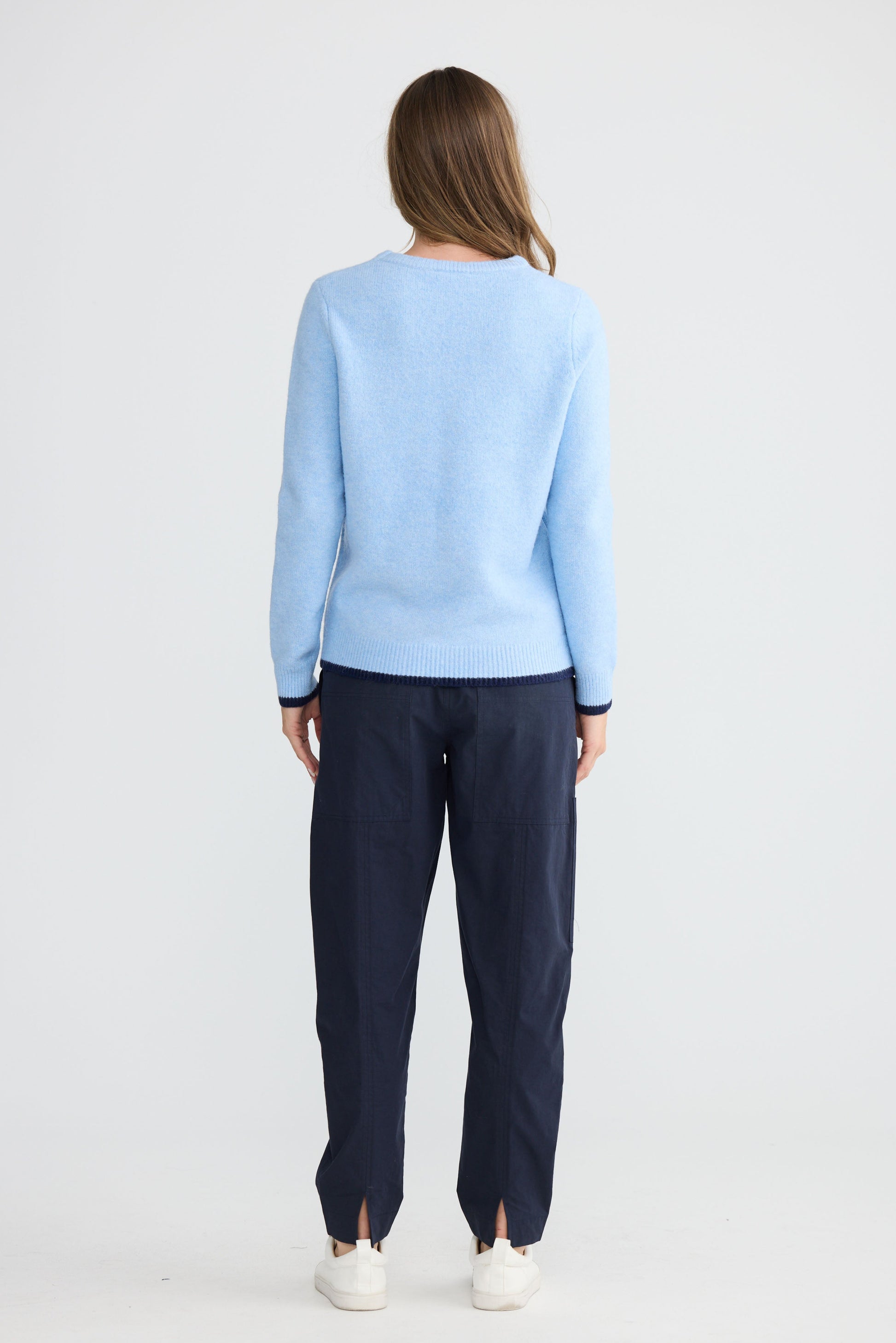 Model wearing Sabbia Knit Blue Multi with contrast tipping and triangle scarf, alternate view on white background