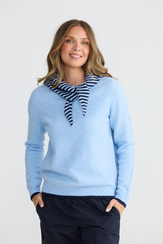 Model wearing Sabbia Knit Blue Multi with contrast tipping and triangle scarf, side view on white background