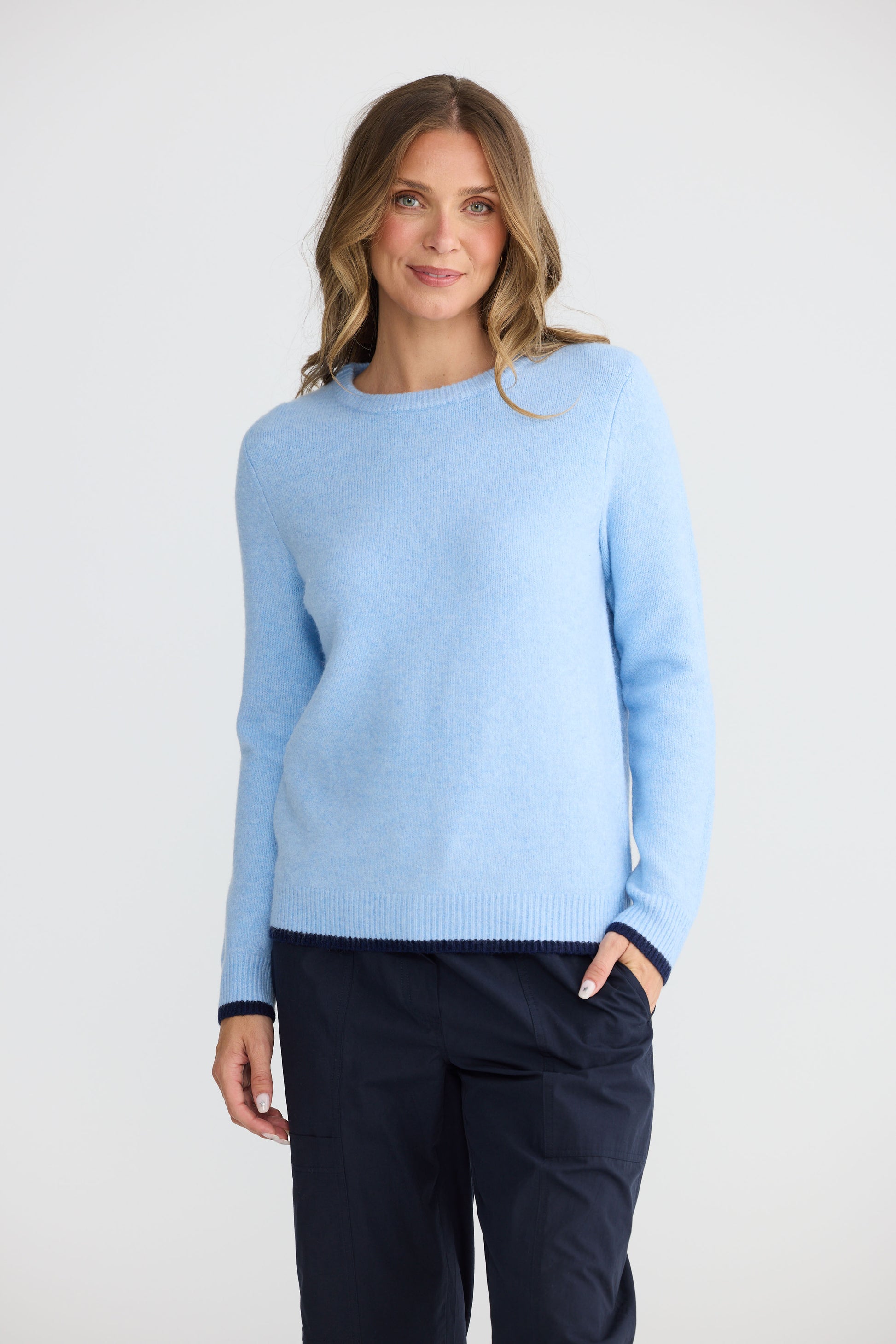 Model wearing Sabbia Knit Blue Multi with contrast tipping and triangle scarf, detail view on white background