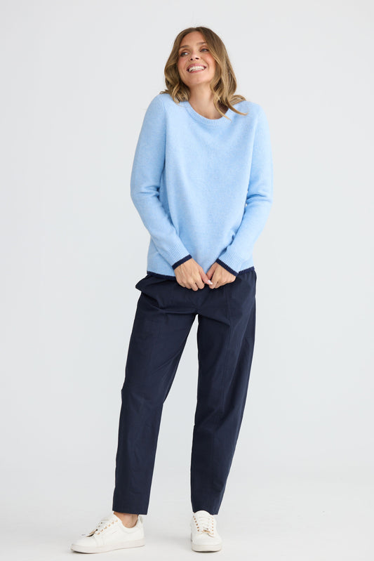 Model wearing Sabbia Knit Blue Multi with contrast tipping and triangle scarf, full-length view on white background
