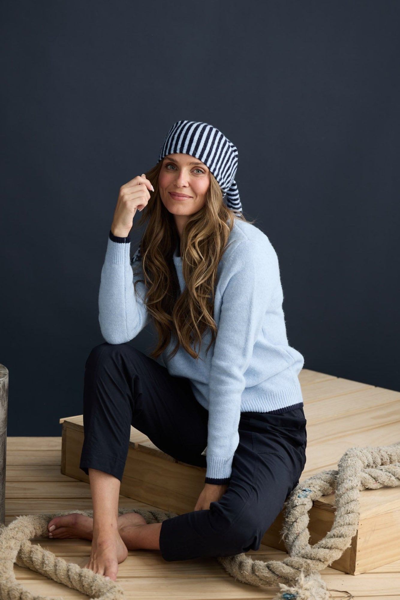 Model wearing Sabbia Knit Blue Multi with contrast tipping and triangle scarf, campaign lifestyle view