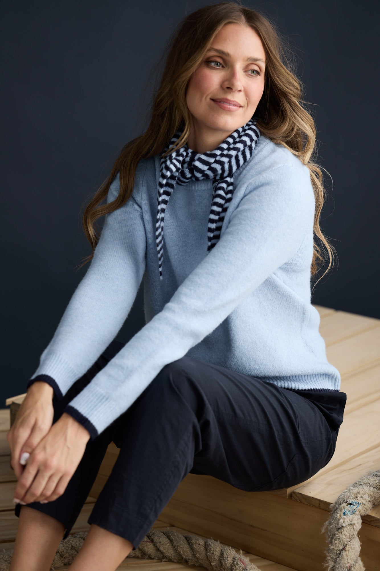 Model wearing Sabbia Knit Blue Multi with contrast tipping and triangle scarf, campaign lifestyle view