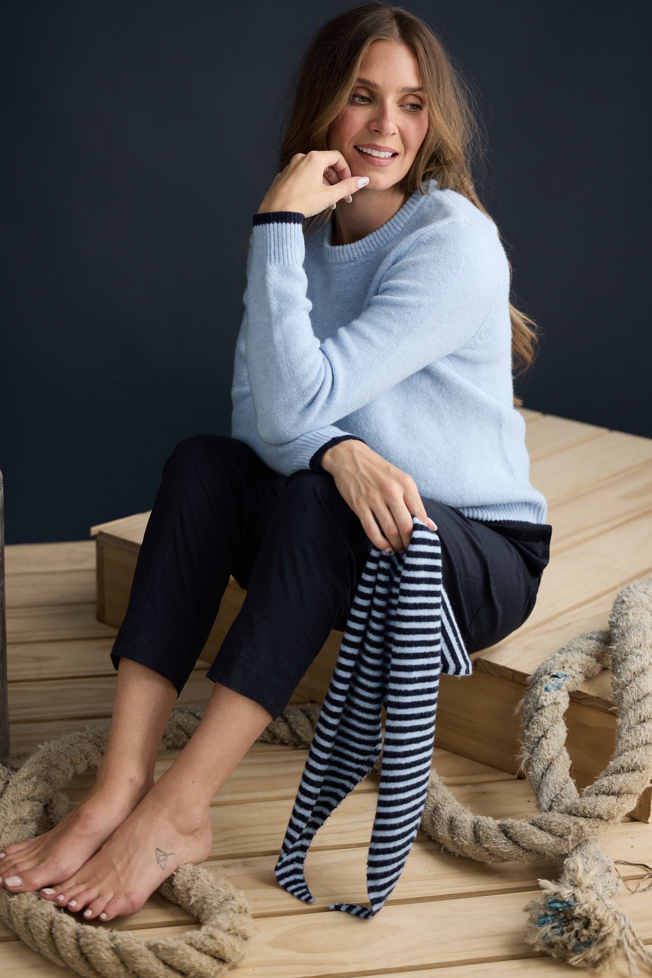 Model wearing Sabbia Knit Blue Multi with contrast tipping and triangle scarf, campaign lifestyle view