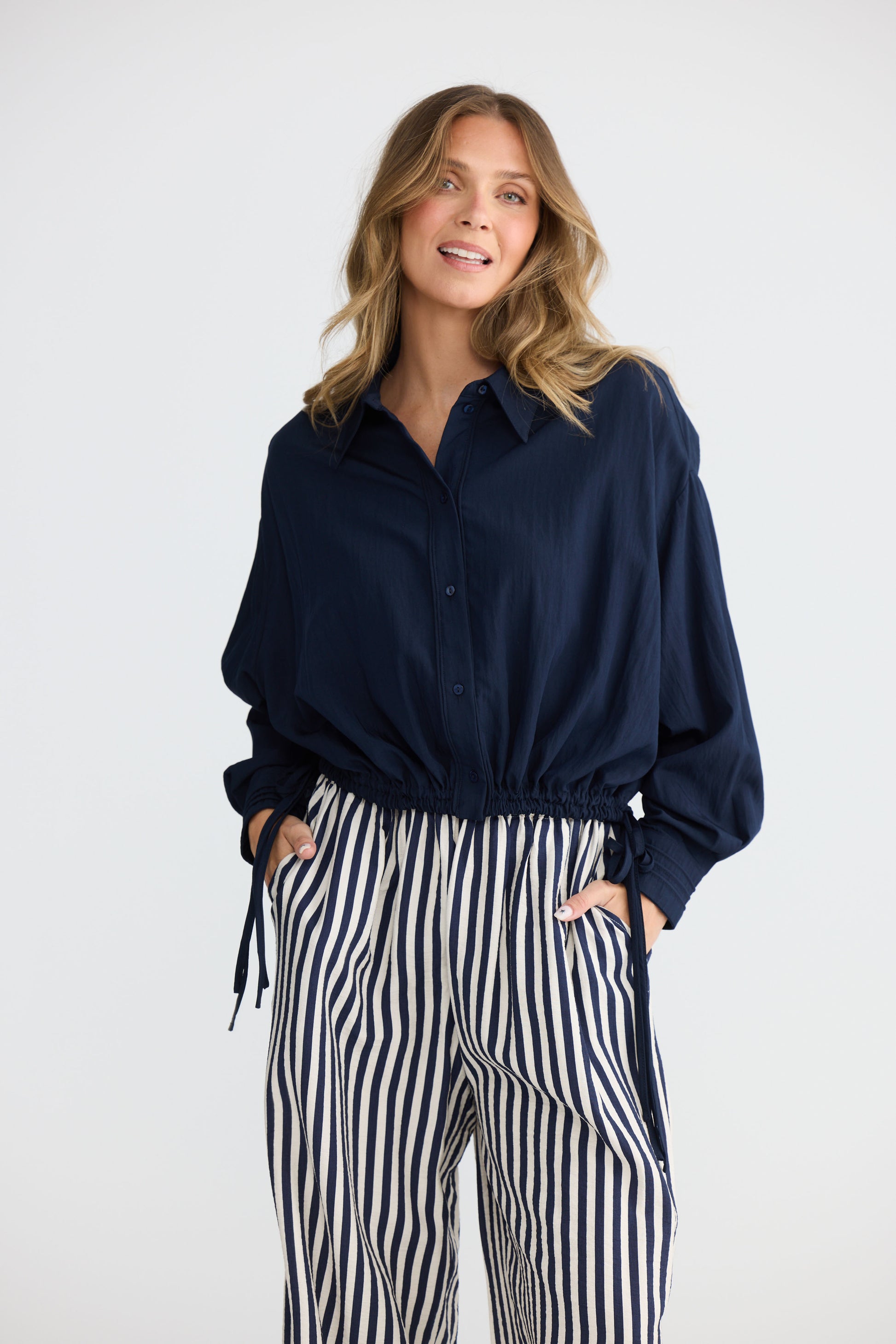 Model wearing Ripple Shirt Navy with relaxed shirt silhouette, alternate view on white background