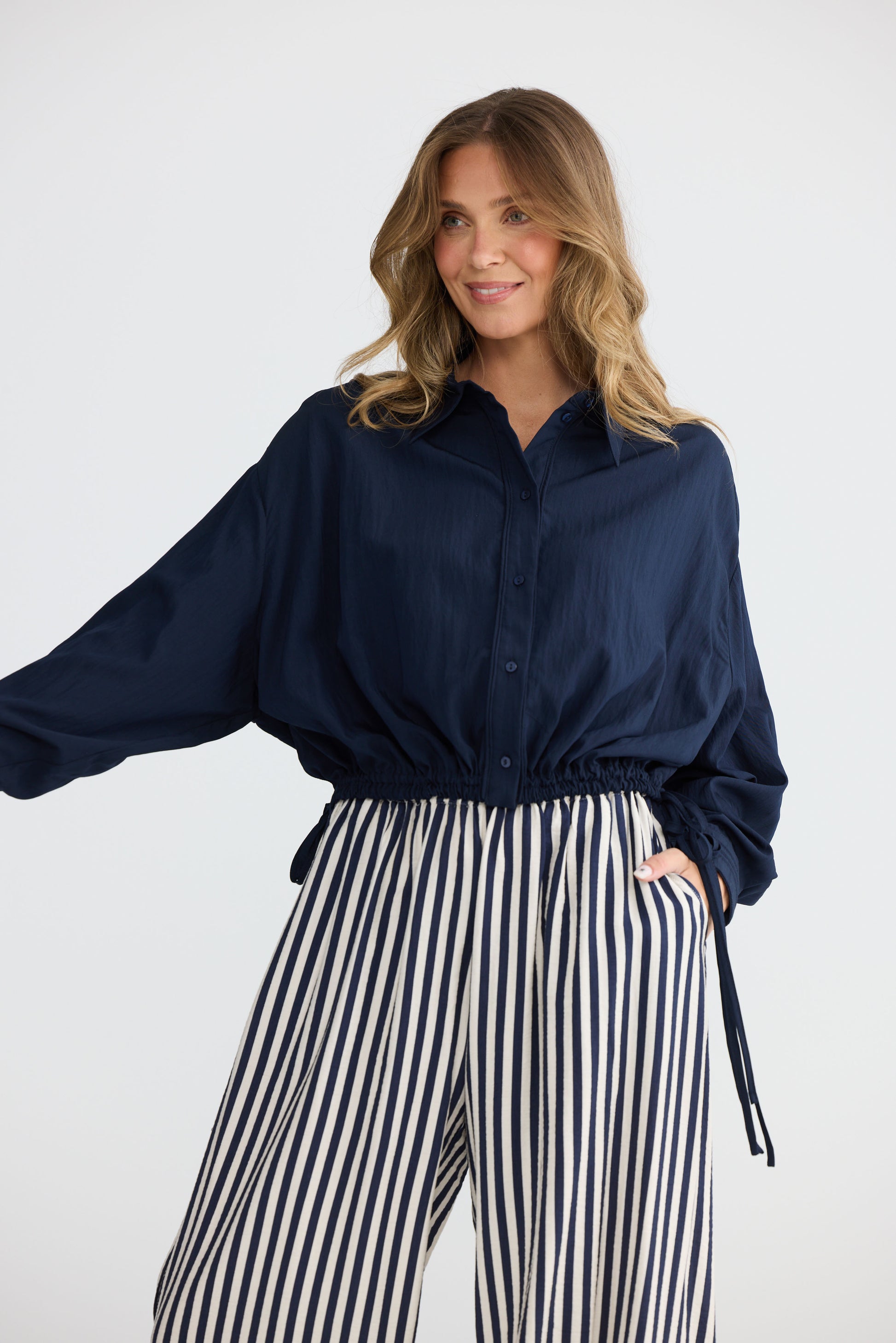 Model wearing Ripple Shirt Navy with relaxed shirt silhouette, back view on white background