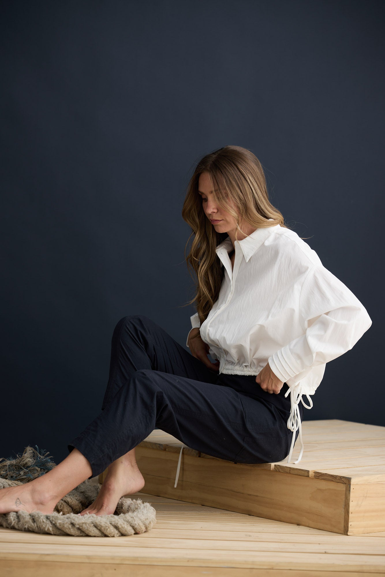 Model wearing Fae Shirt White with contrast buttons and stitching, campaign lifestyle view