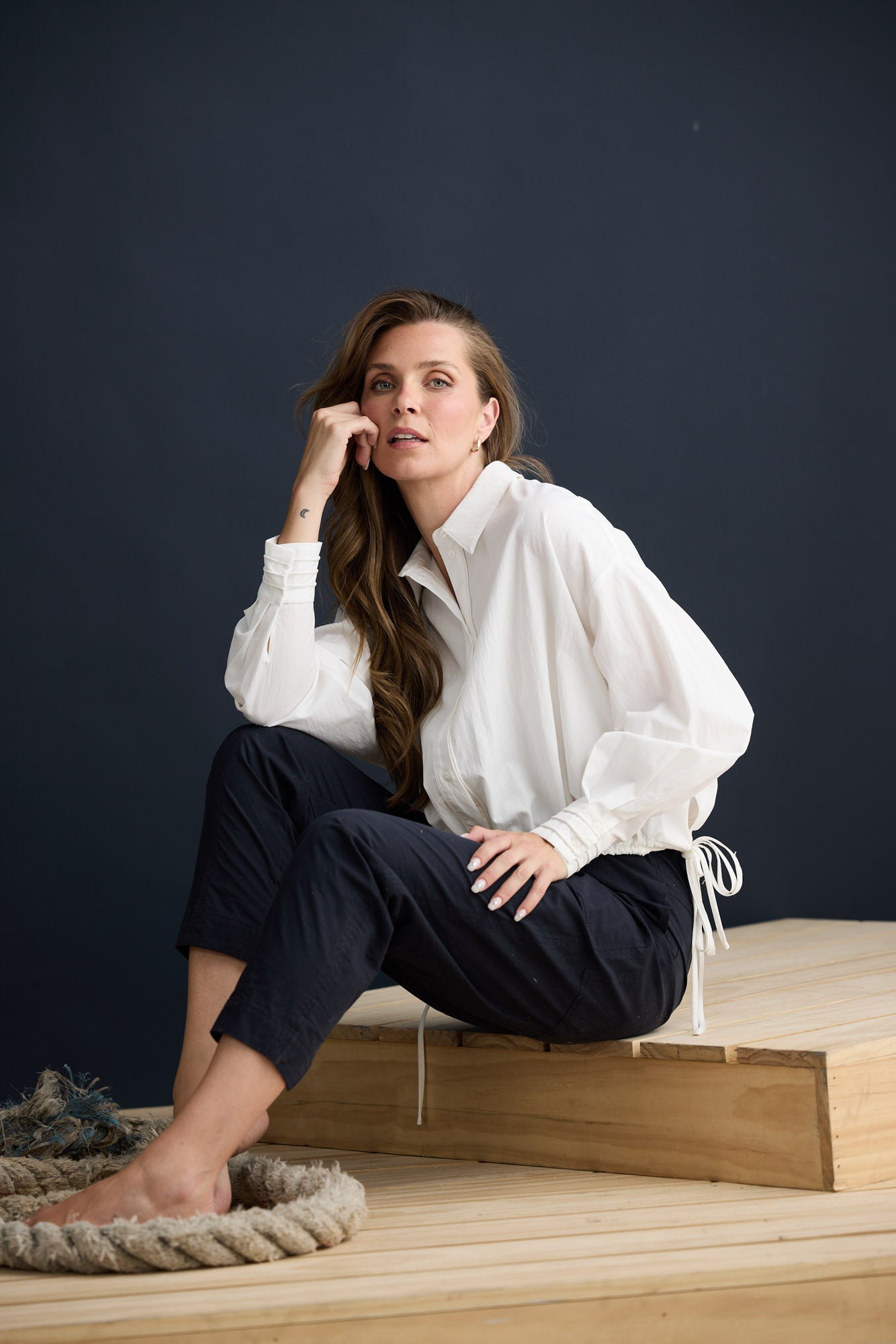 Model wearing Fae Shirt White with contrast buttons and stitching, campaign lifestyle view