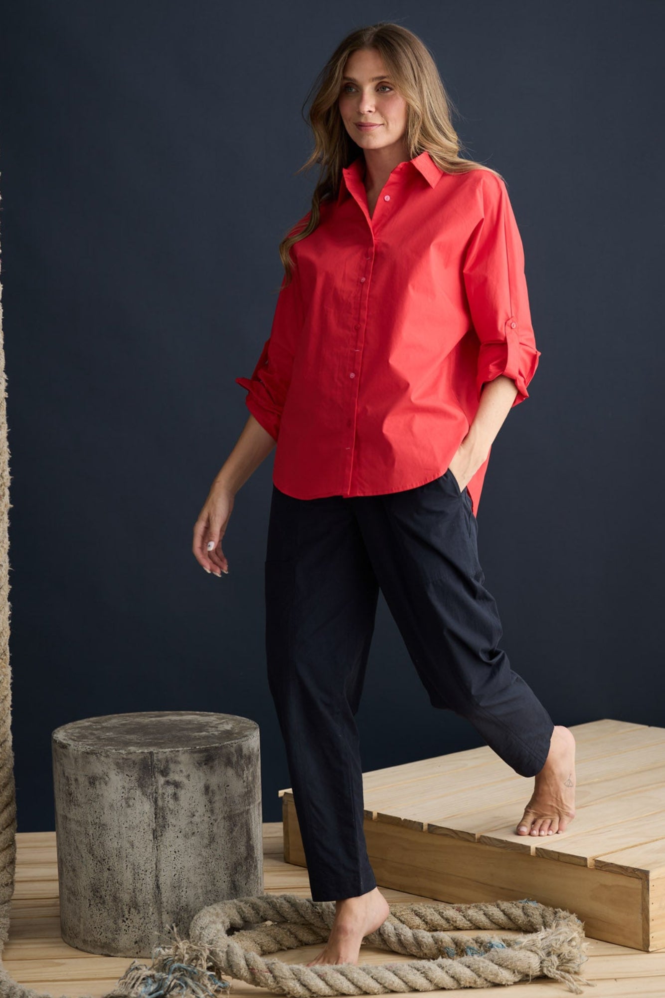 Model wearing Fae Shirt Red with contrast buttons and stitching, campaign lifestyle view