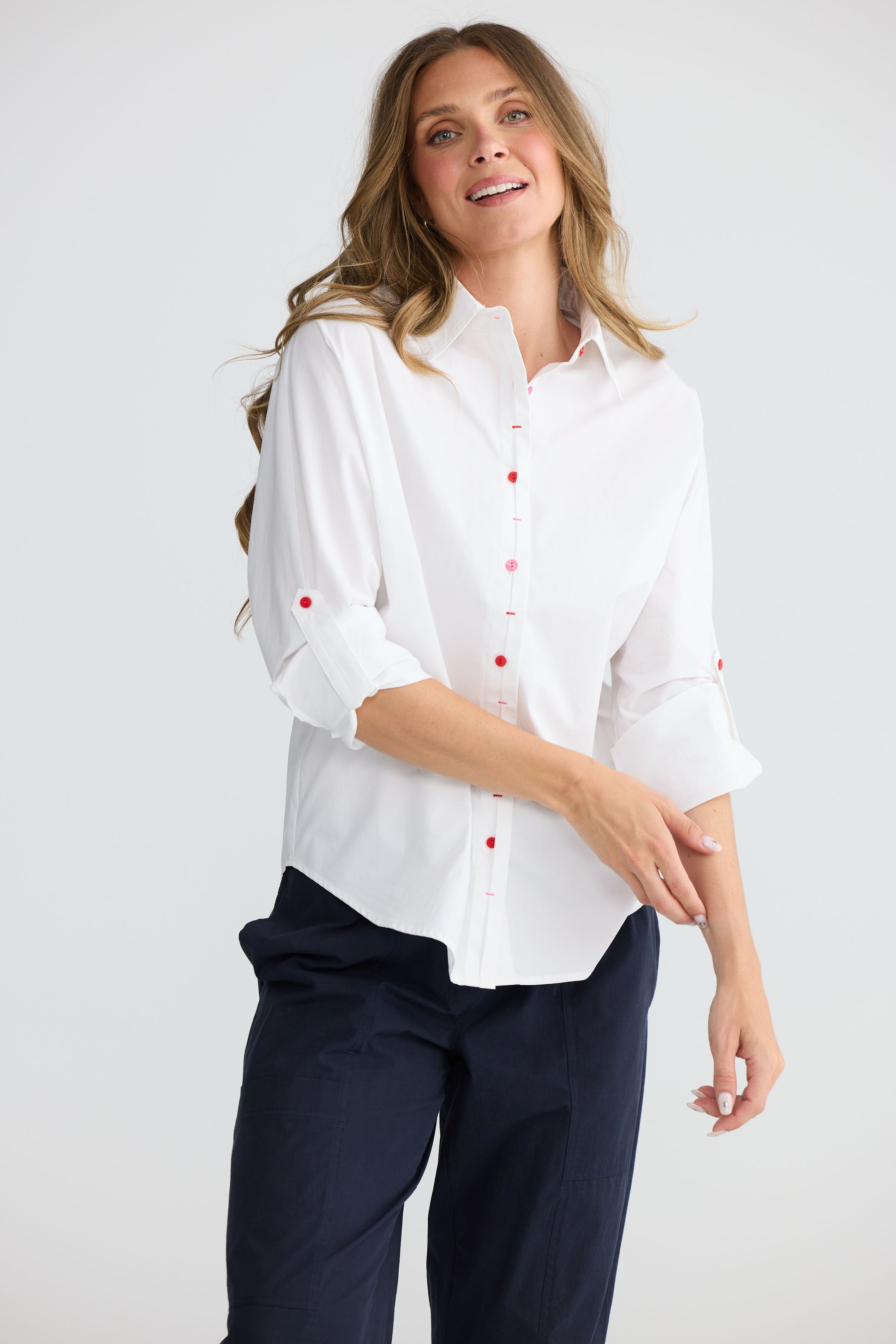 Model wearing Fae Shirt White with contrast buttons and stitching, front view on white background