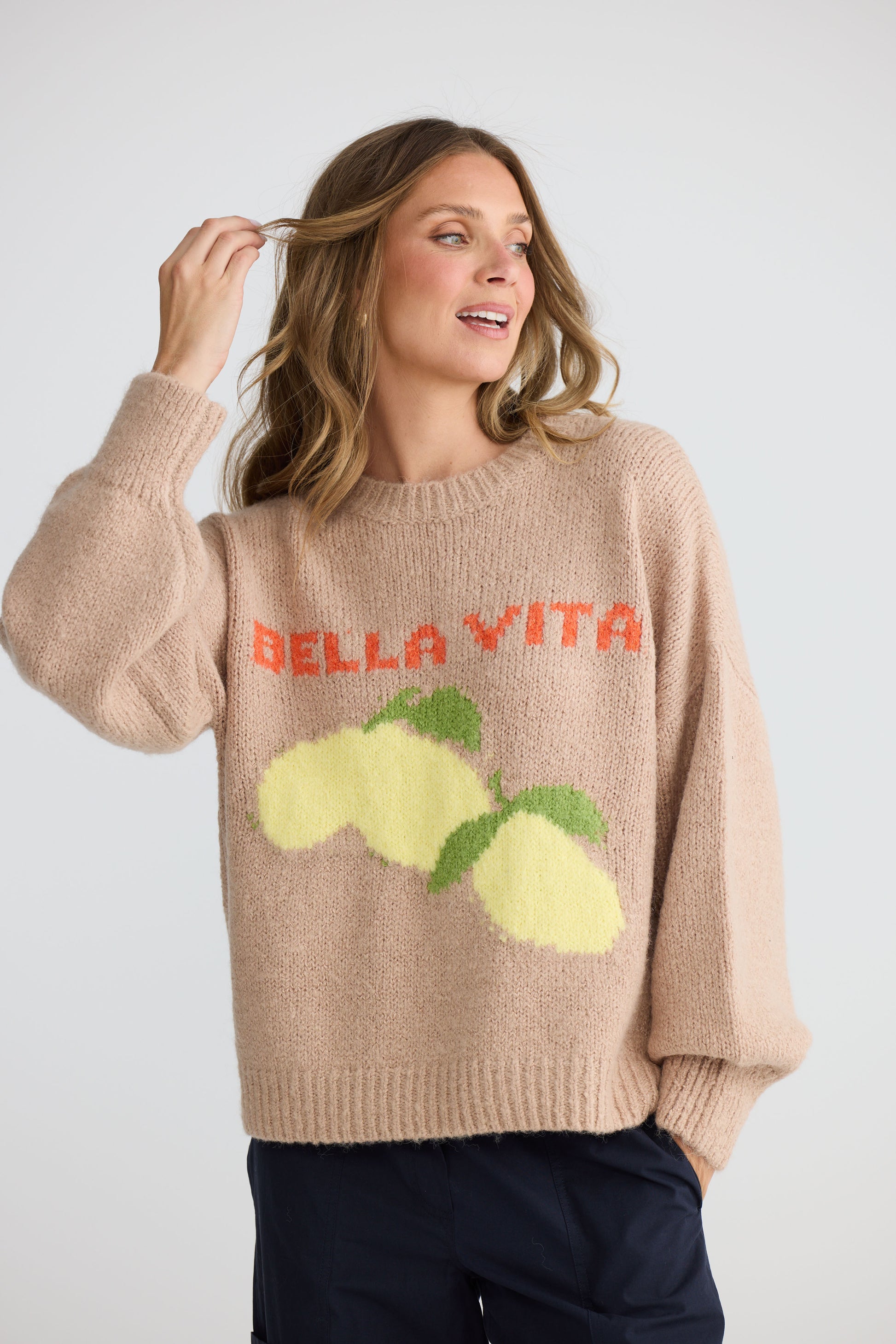 Model wearing Bella Vita Knit Oatmeal with oversized relaxed fit, back view on white background