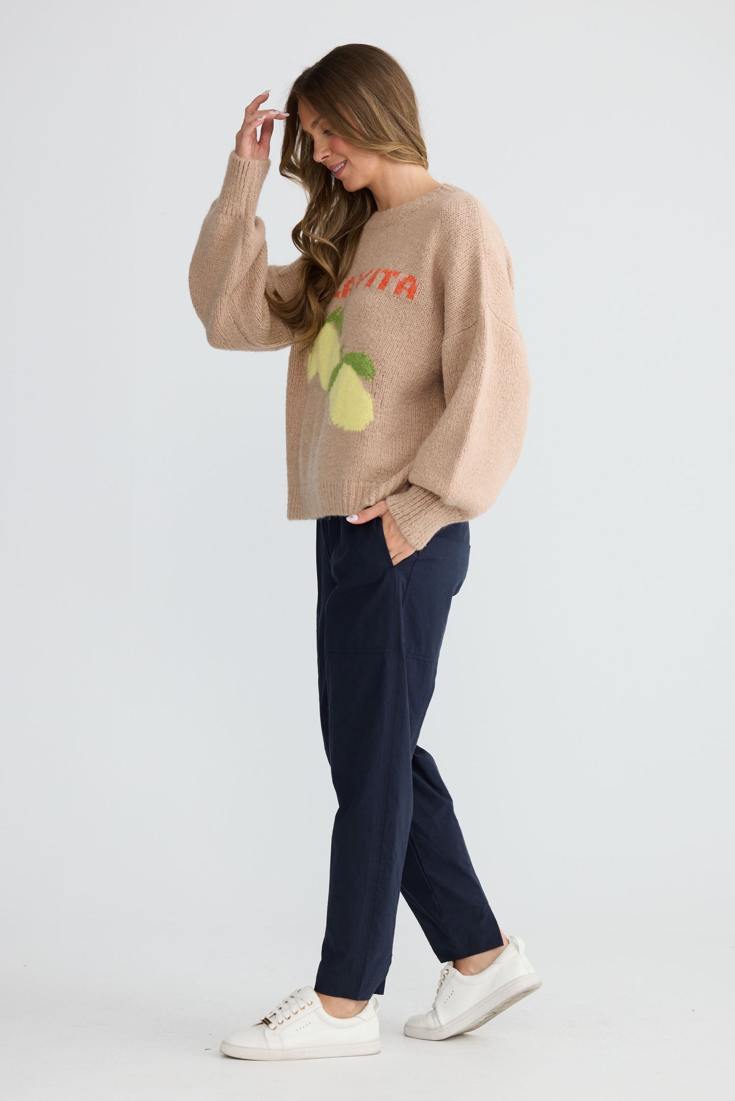 Model wearing Bella Vita Knit Oatmeal with oversized relaxed fit, side view on white background