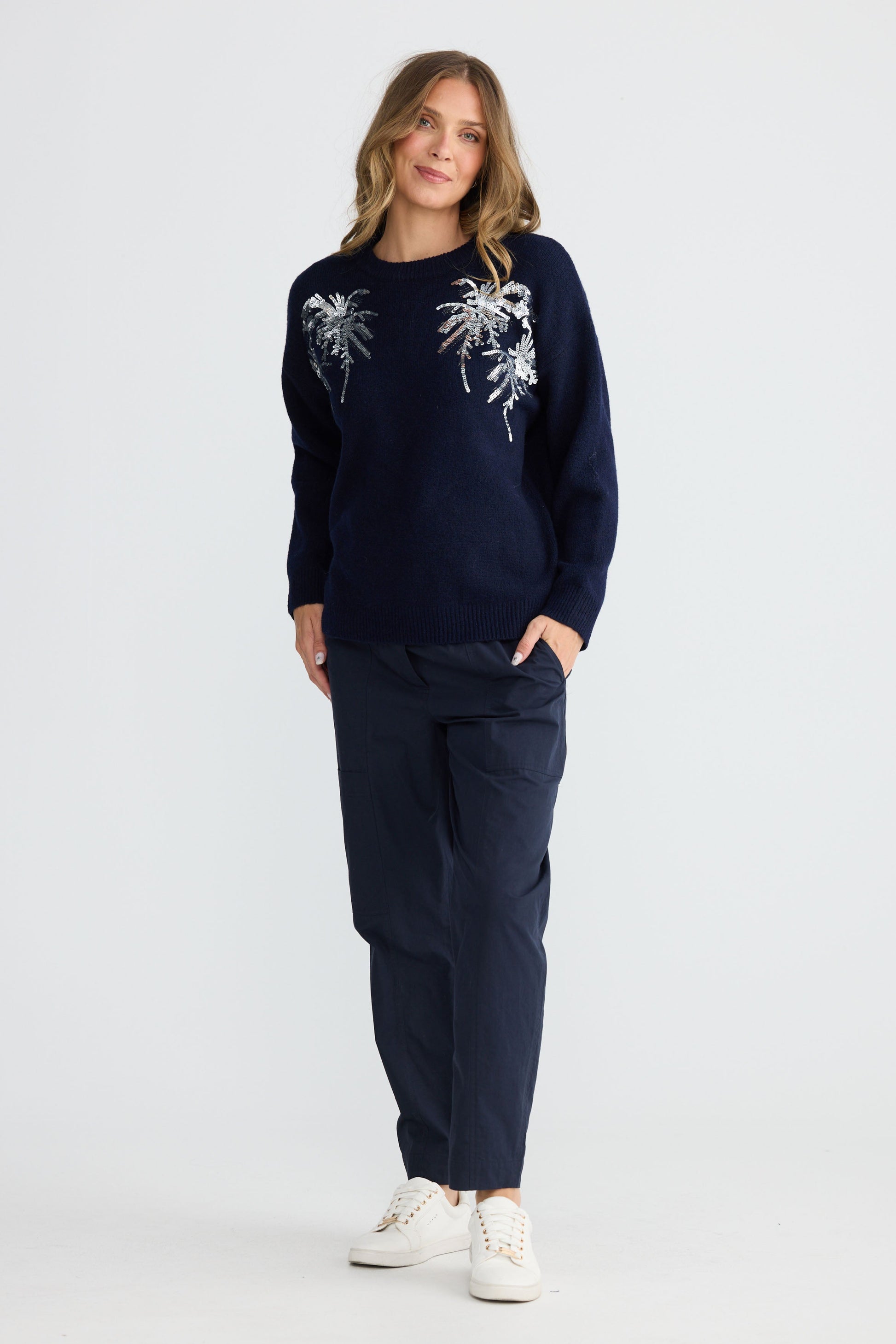 Model wearing Paradise Knit Navy with dropped shoulder and relaxed fit, back view on white background
