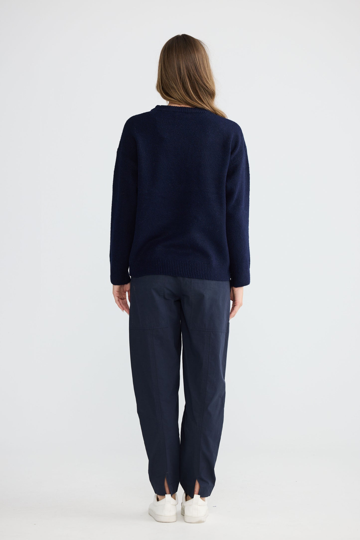 Model wearing Paradise Knit Navy with dropped shoulder and relaxed fit, front view on white background