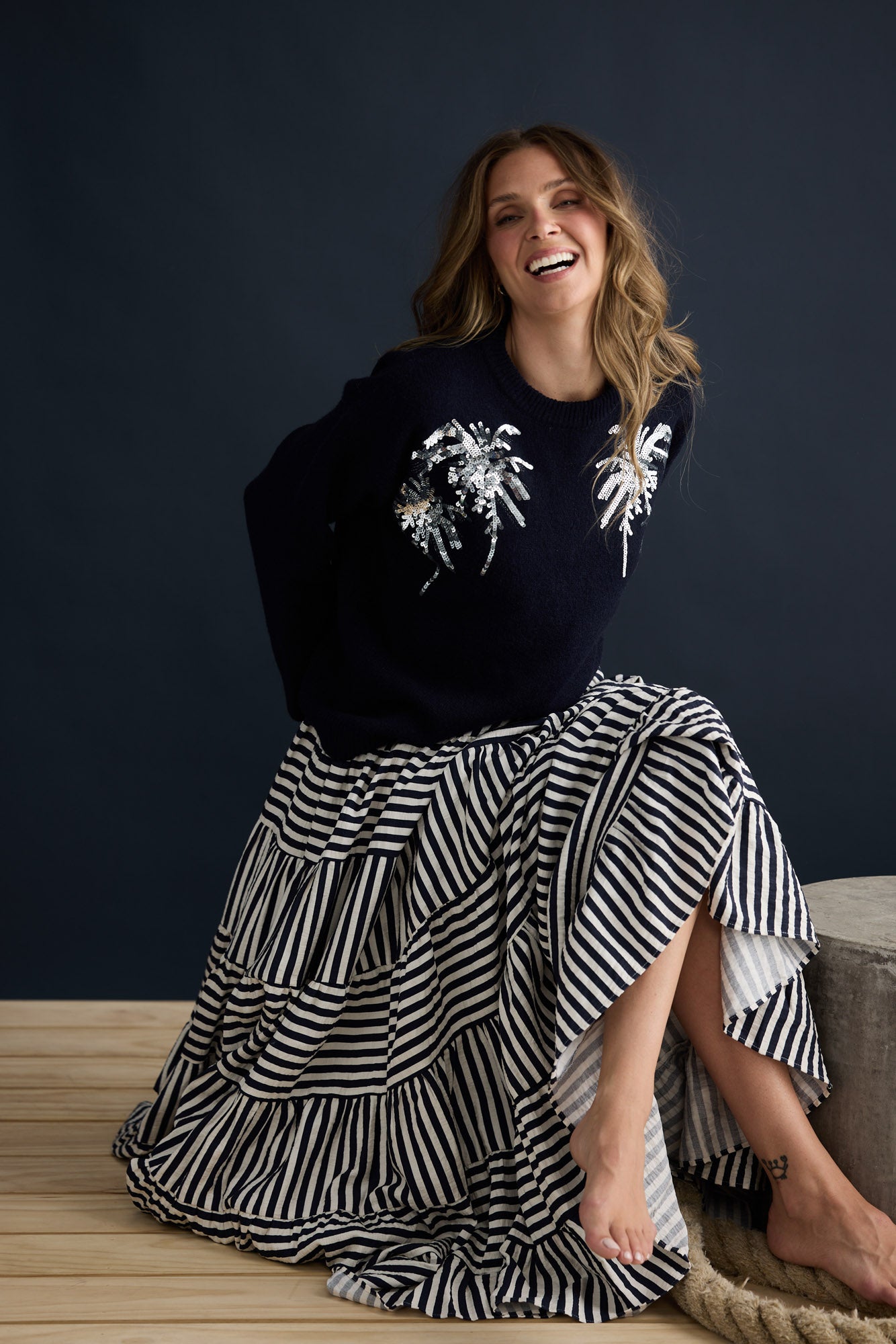 Model wearing Paradise Knit Navy with dropped shoulder and relaxed fit, campaign lifestyle view