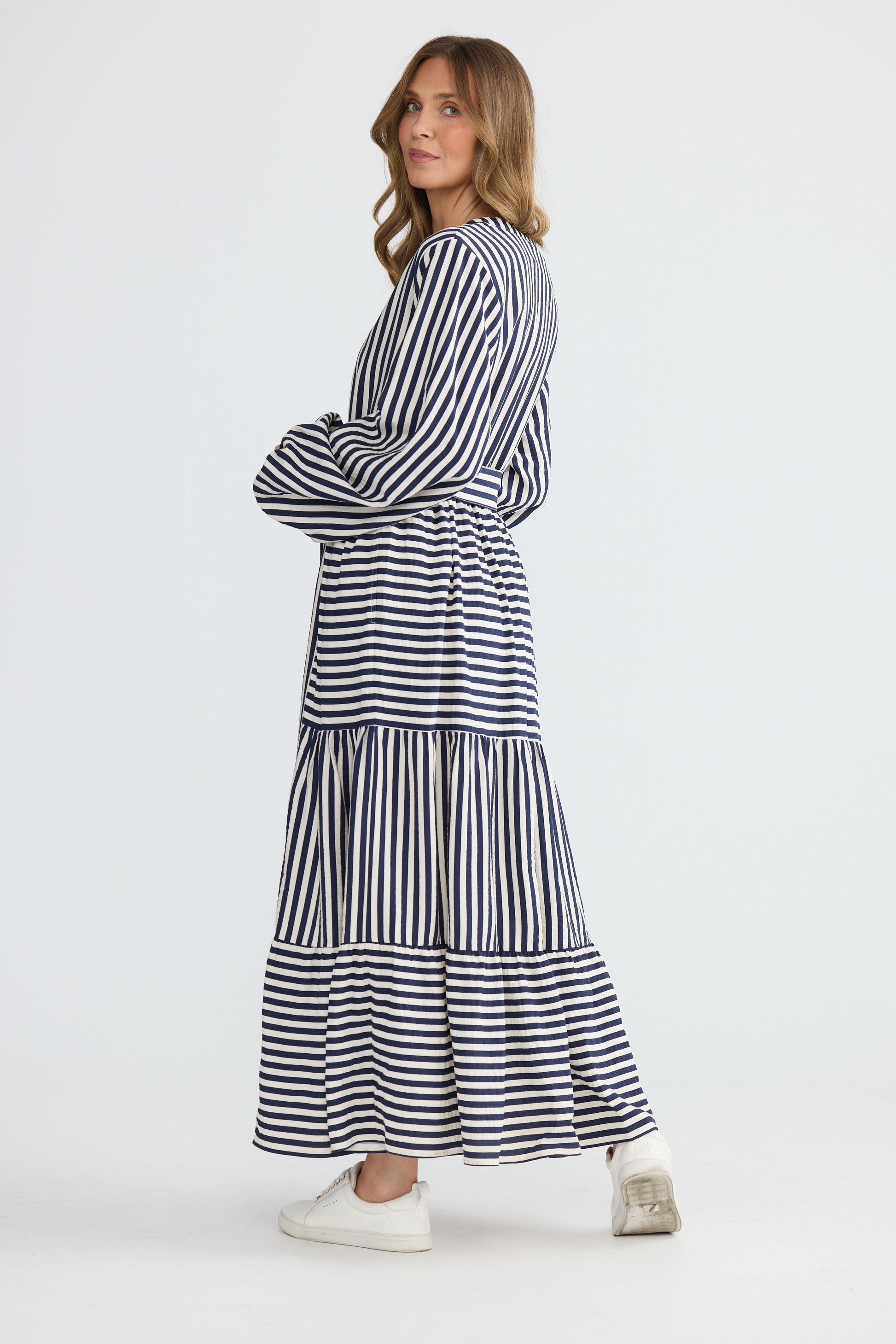 Model wearing Marla Dress Navy and White Stripe with balloon sleeves and waist tie, detail view on white background