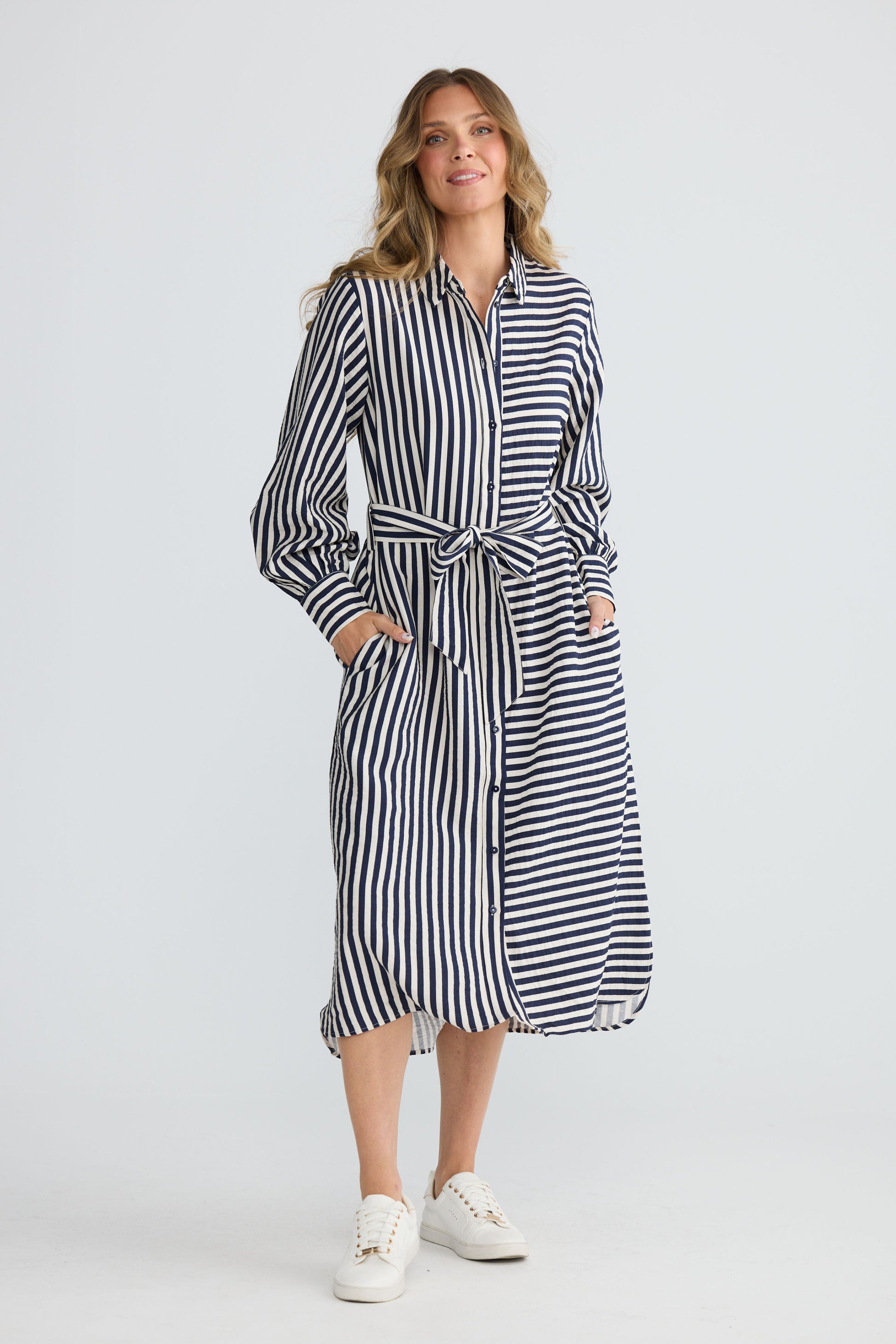 Model wearing Carnation Shirt Dress Navy and White Stripe with waist tie and in-seam pockets, front view on white background