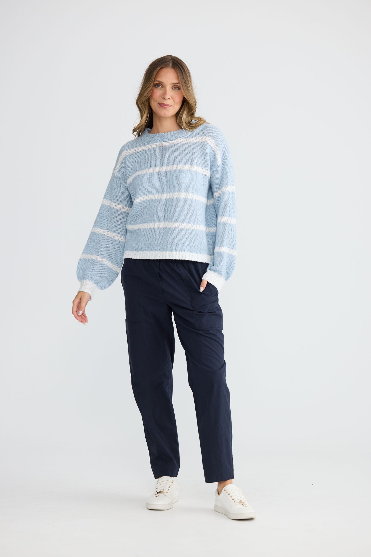 Model wearing Bay Knit Blue Stripe with ribbed trims and relaxed fit, alternate view on white background