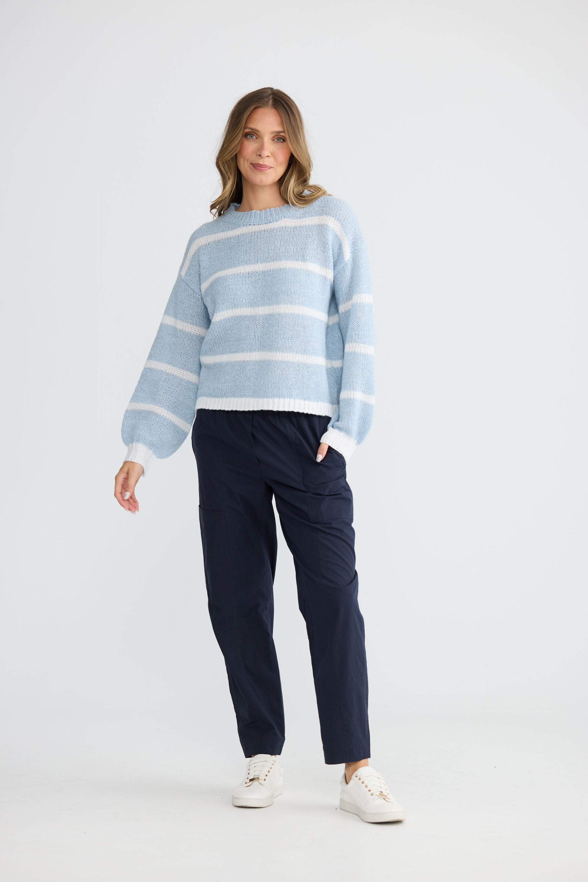 Model wearing Bay Knit Blue Stripe with ribbed trims and relaxed fit, alternate view on white background