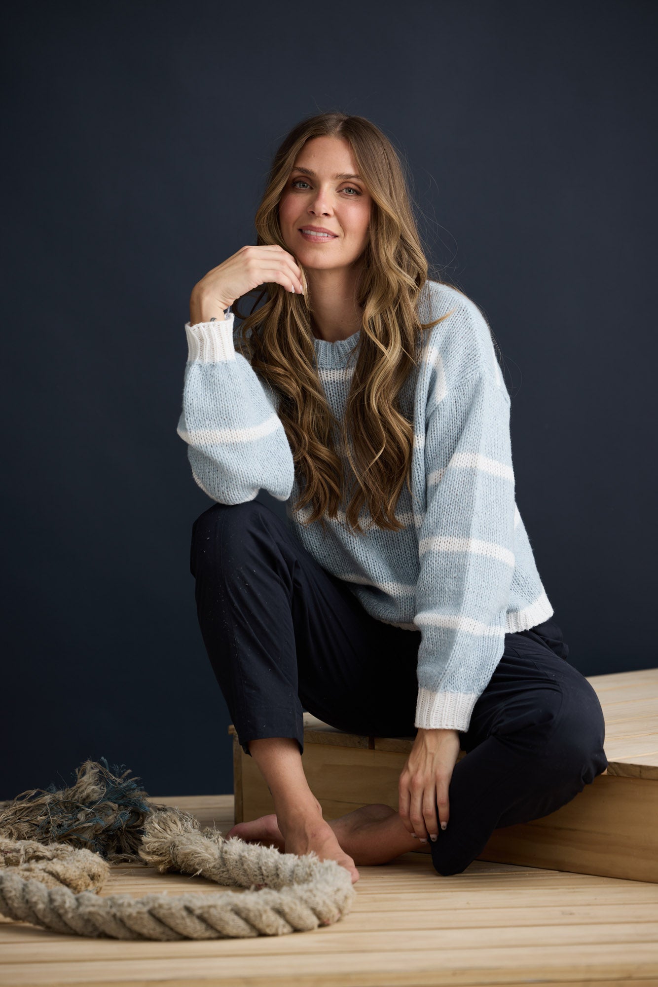Model wearing Bay Knit Blue Stripe with ribbed trims and relaxed fit, campaign lifestyle view