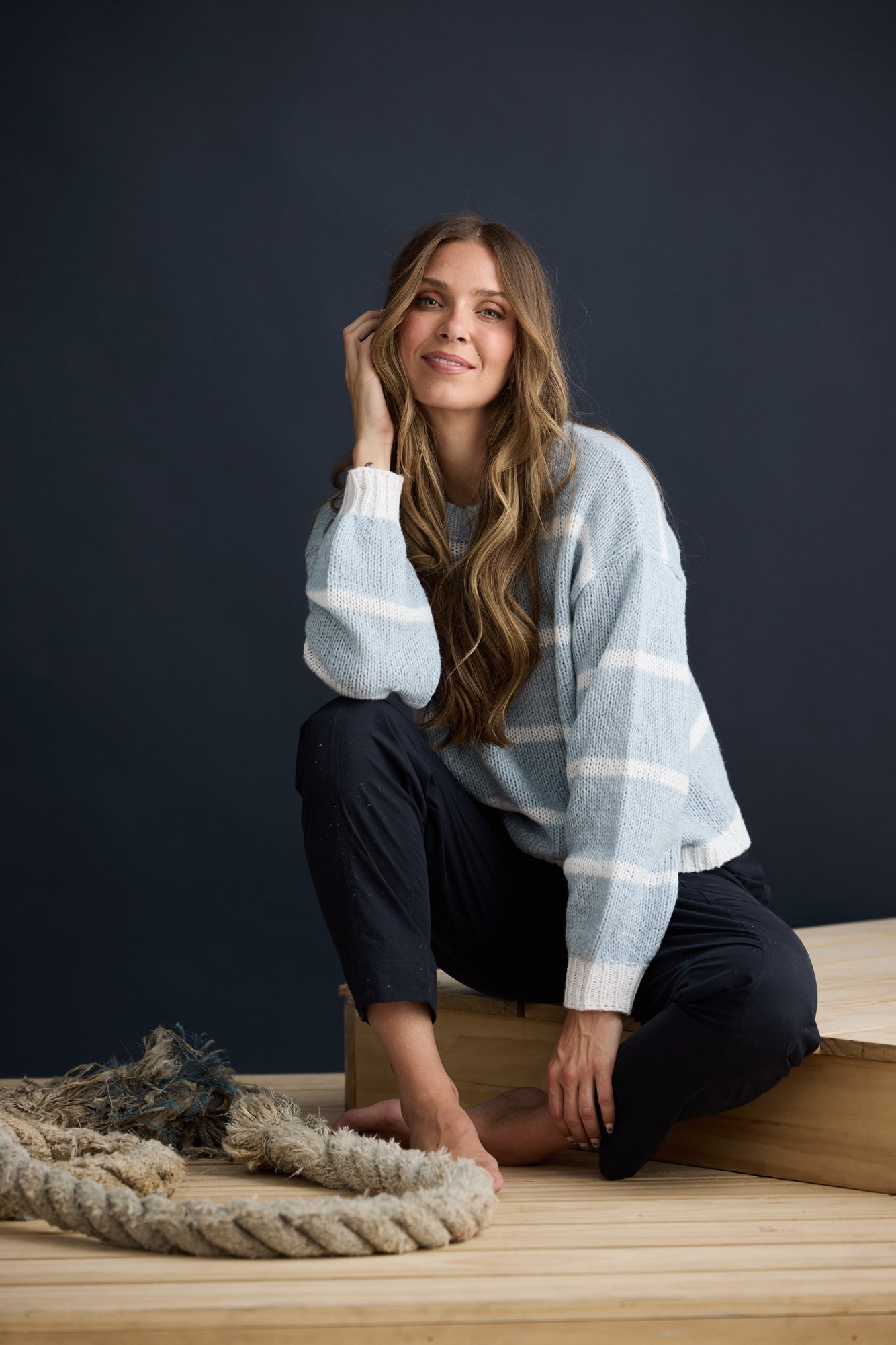 Model wearing Bay Knit Blue Stripe with ribbed trims and relaxed fit, campaign lifestyle view